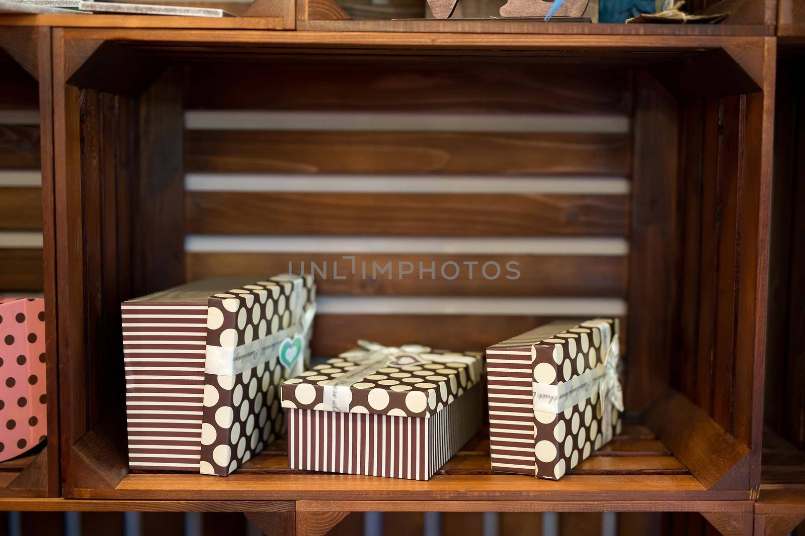 Gift boxes on a wooden background on a showcase