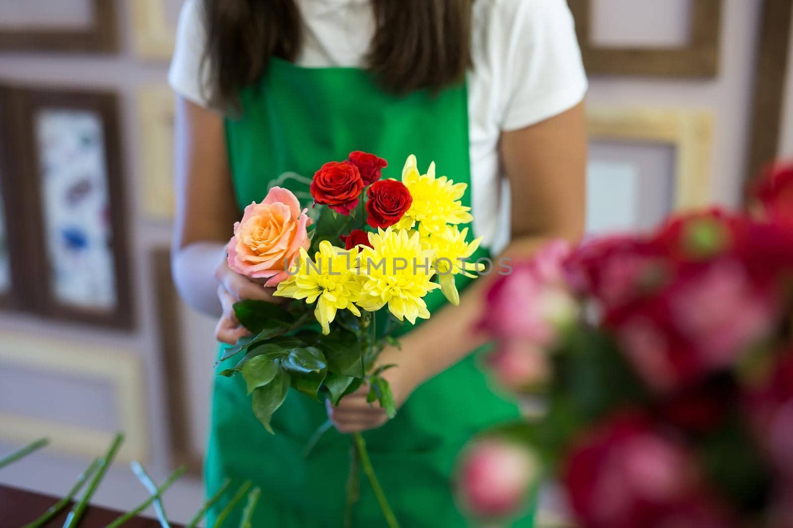 Workshop florist, making bouquets and flower arrangements. Woman collecting a bouquet of flowers