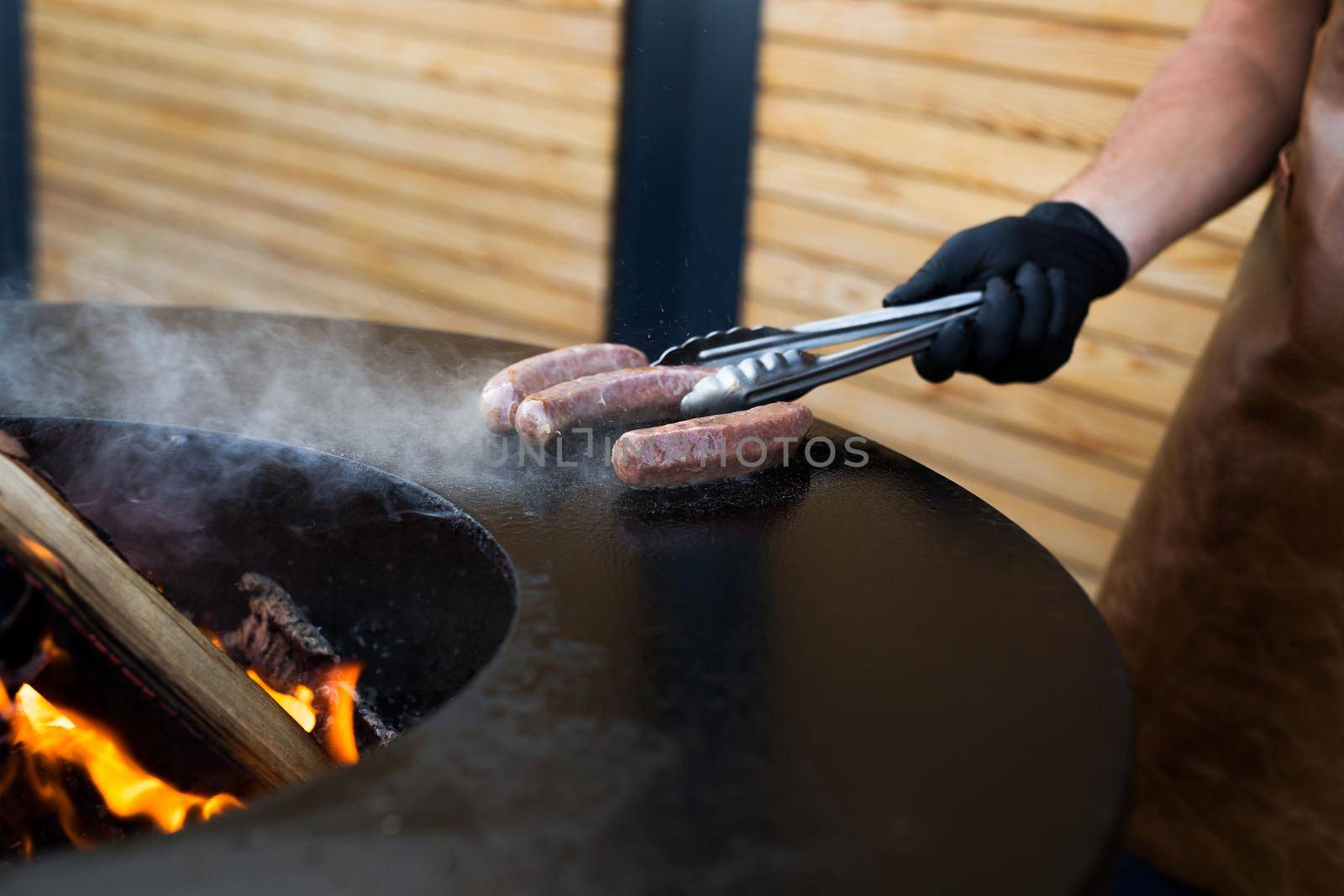 Sausage on Barbeque Smoker Grill. Hot and smoked sausage. Food Festival. by StudioPeace