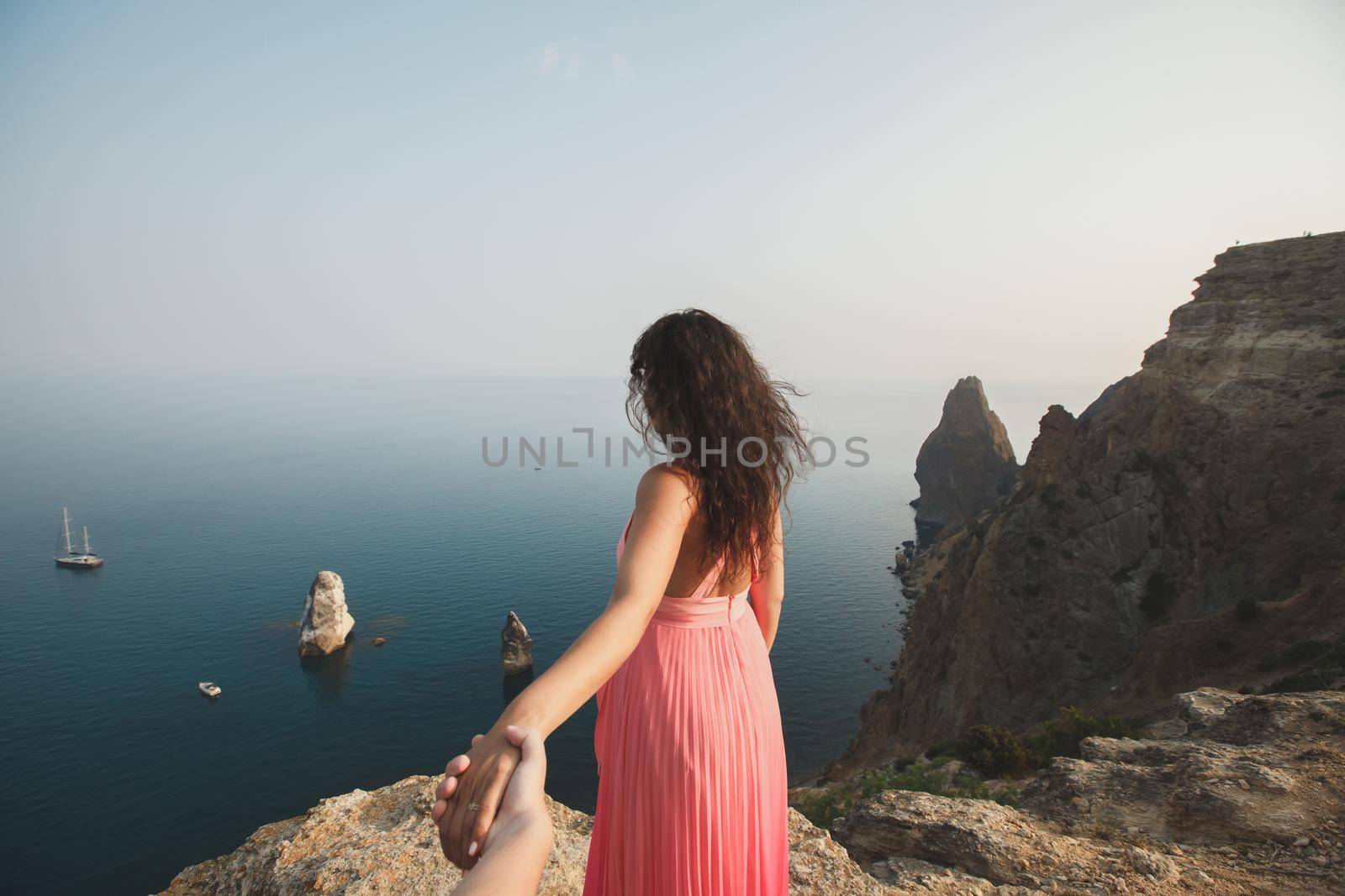 A man and a woman stand on the mountain.