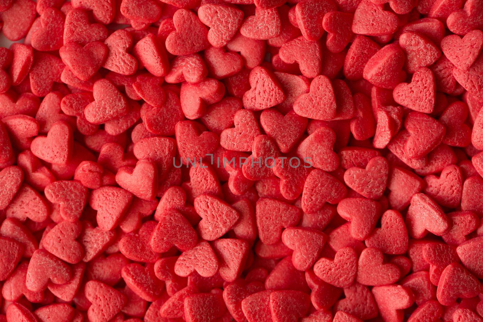 Small red candy hearts, close-up. Macro photography. by StudioPeace