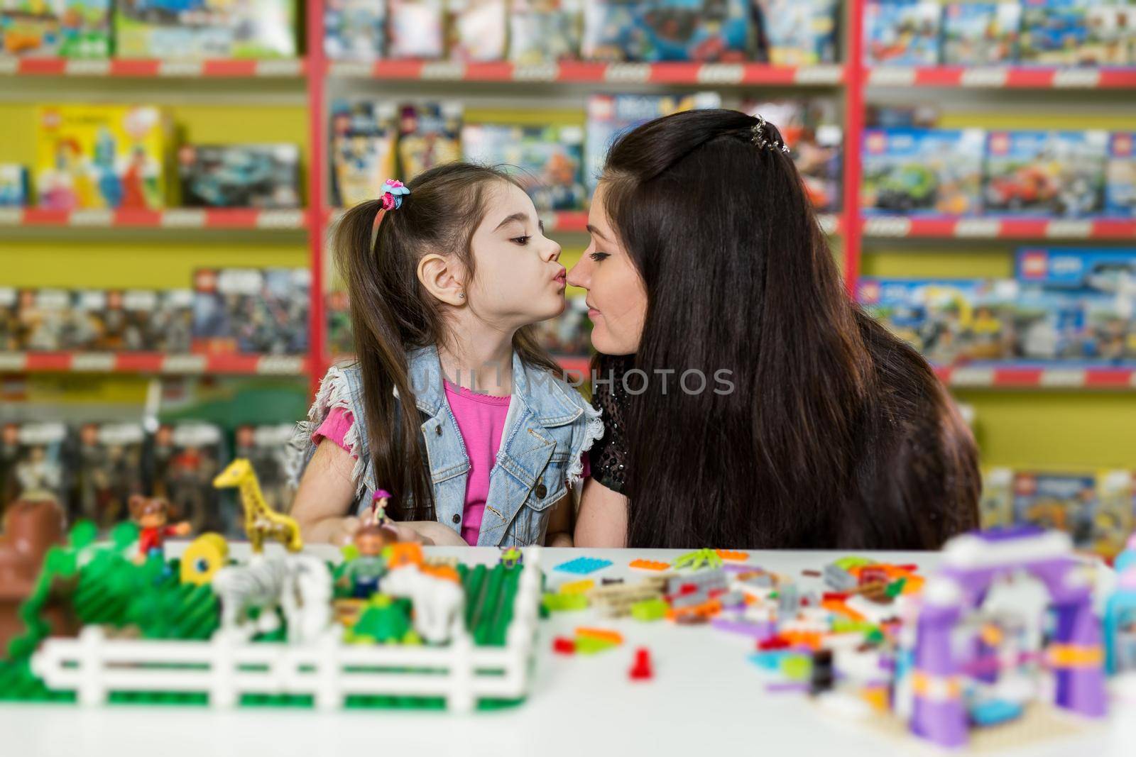 Mother with a little daughter playing with blocks. by StudioPeace