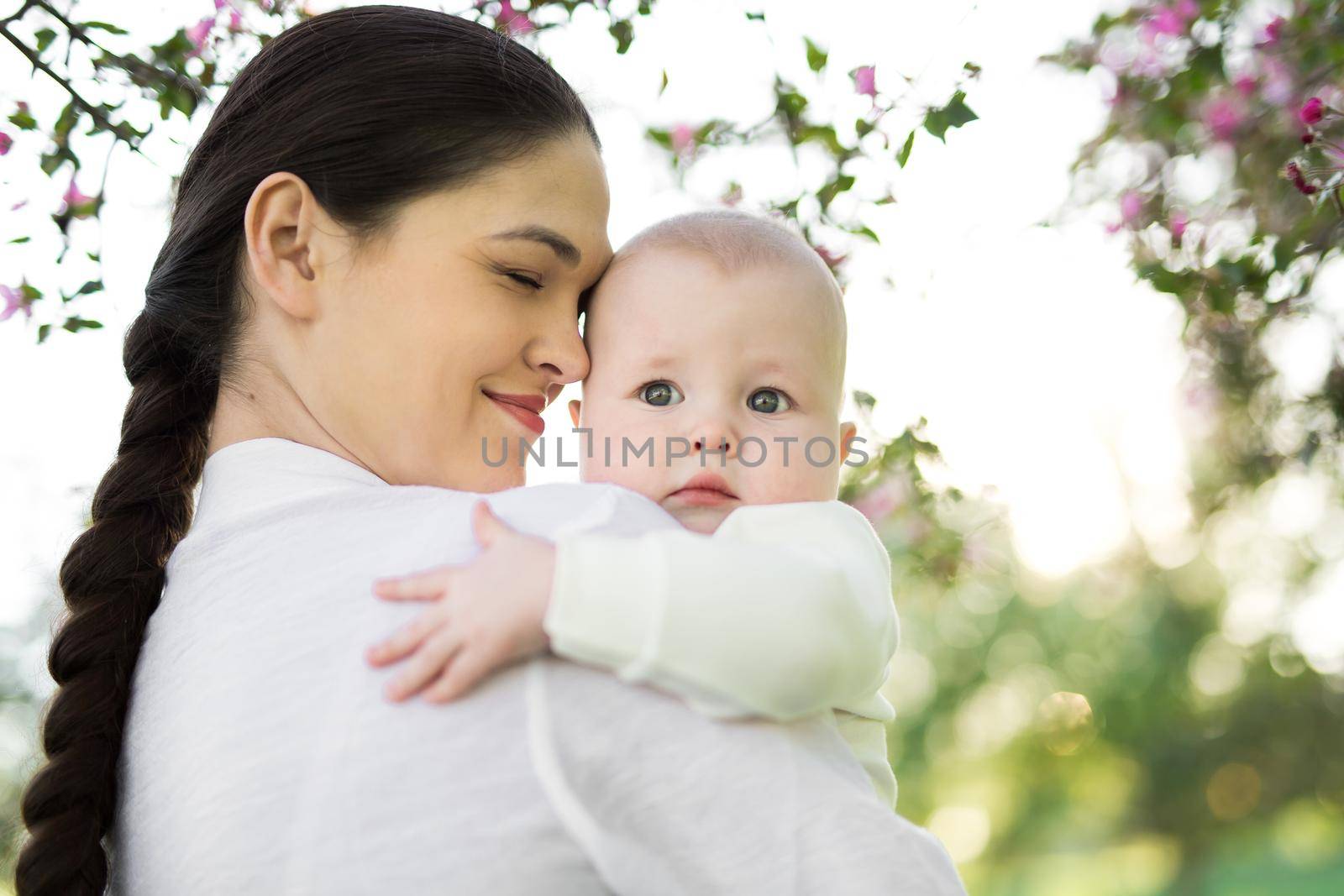 Portrait Beautiful Mother And Baby outdoors. Nature. Beauty Mum and her Child playing in Park. by StudioPeace