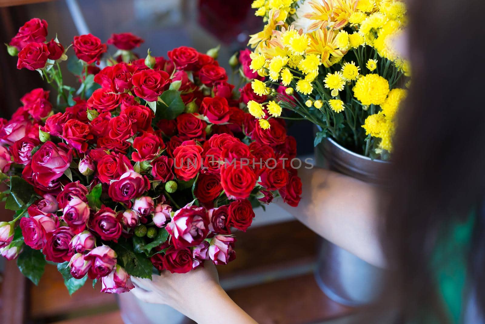 Workshop florist, making bouquets and flower arrangements. Woman collecting a bouquet of flowers