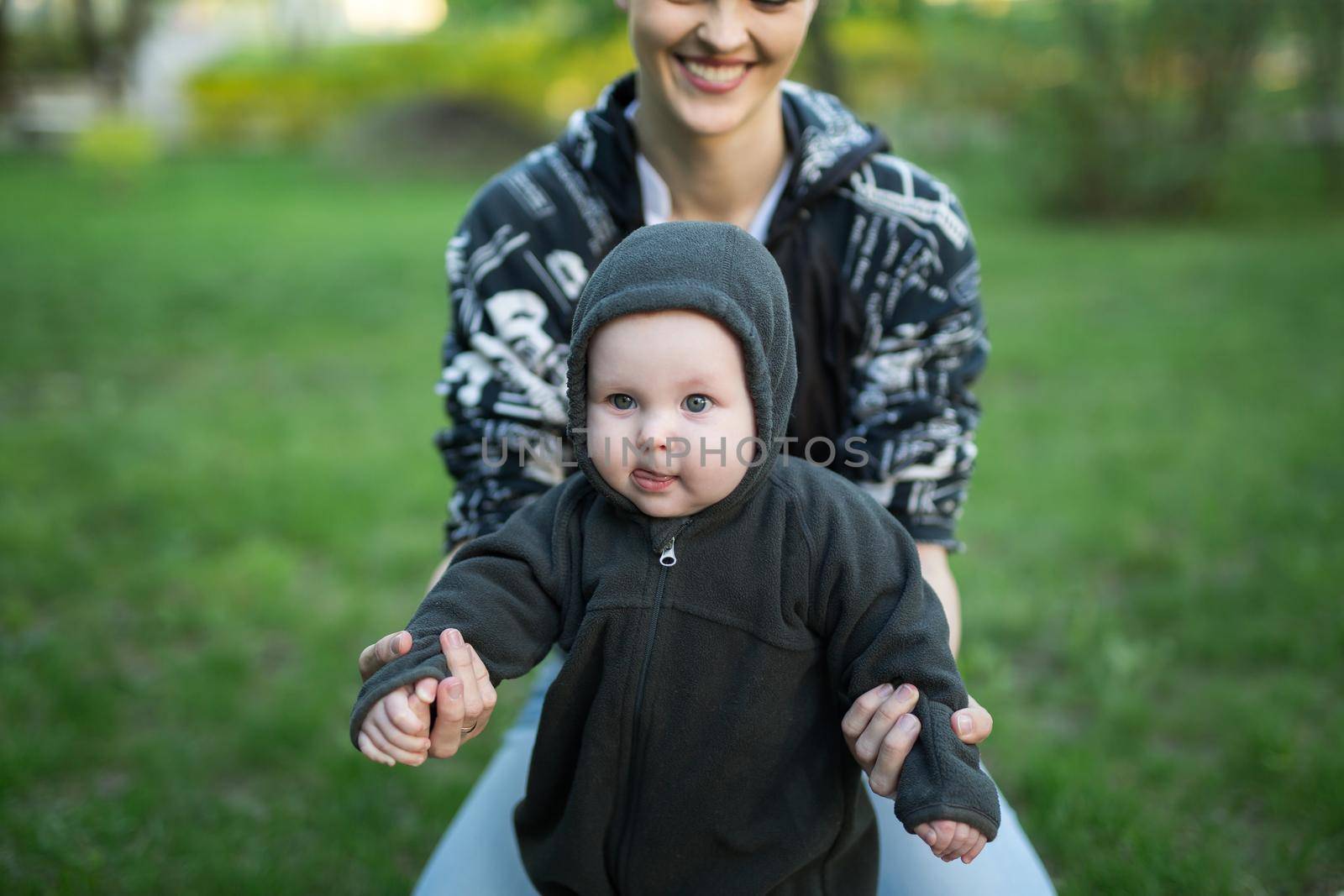 Beautiful Mother And Baby outdoors. Nature. Beauty Mum and her Child playing in Park. by StudioPeace