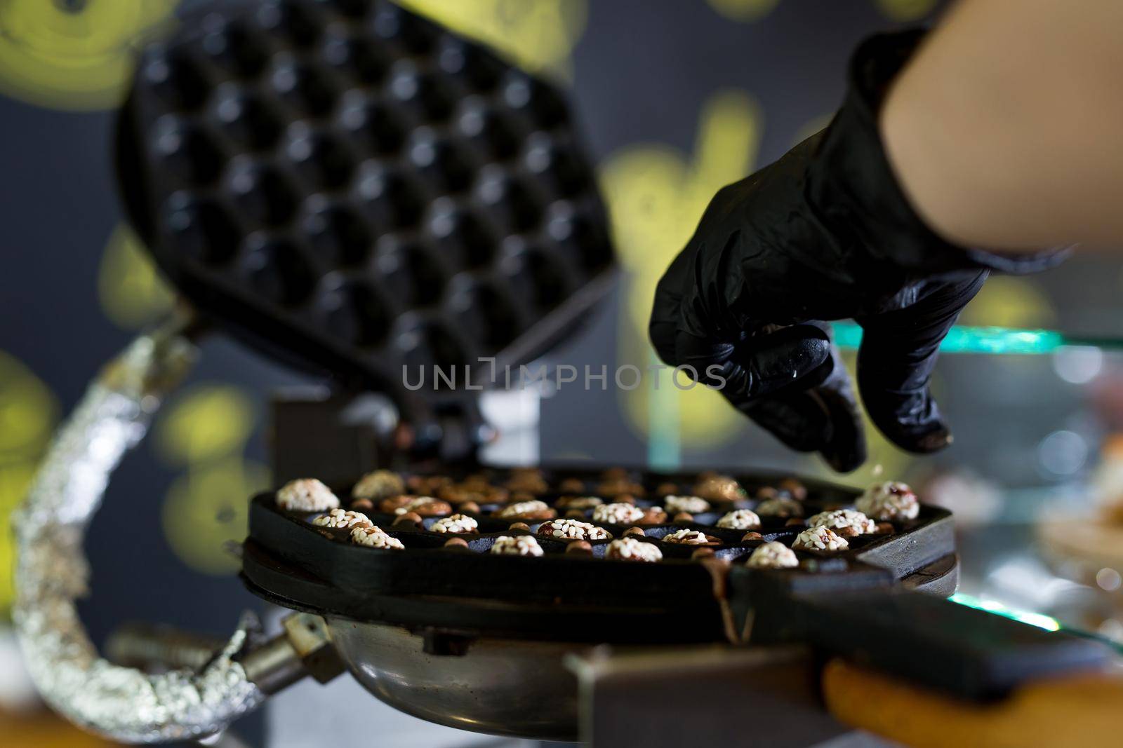 Waffle iron in the kitchen at shop. Preparing Hong Kong waffle. by StudioPeace