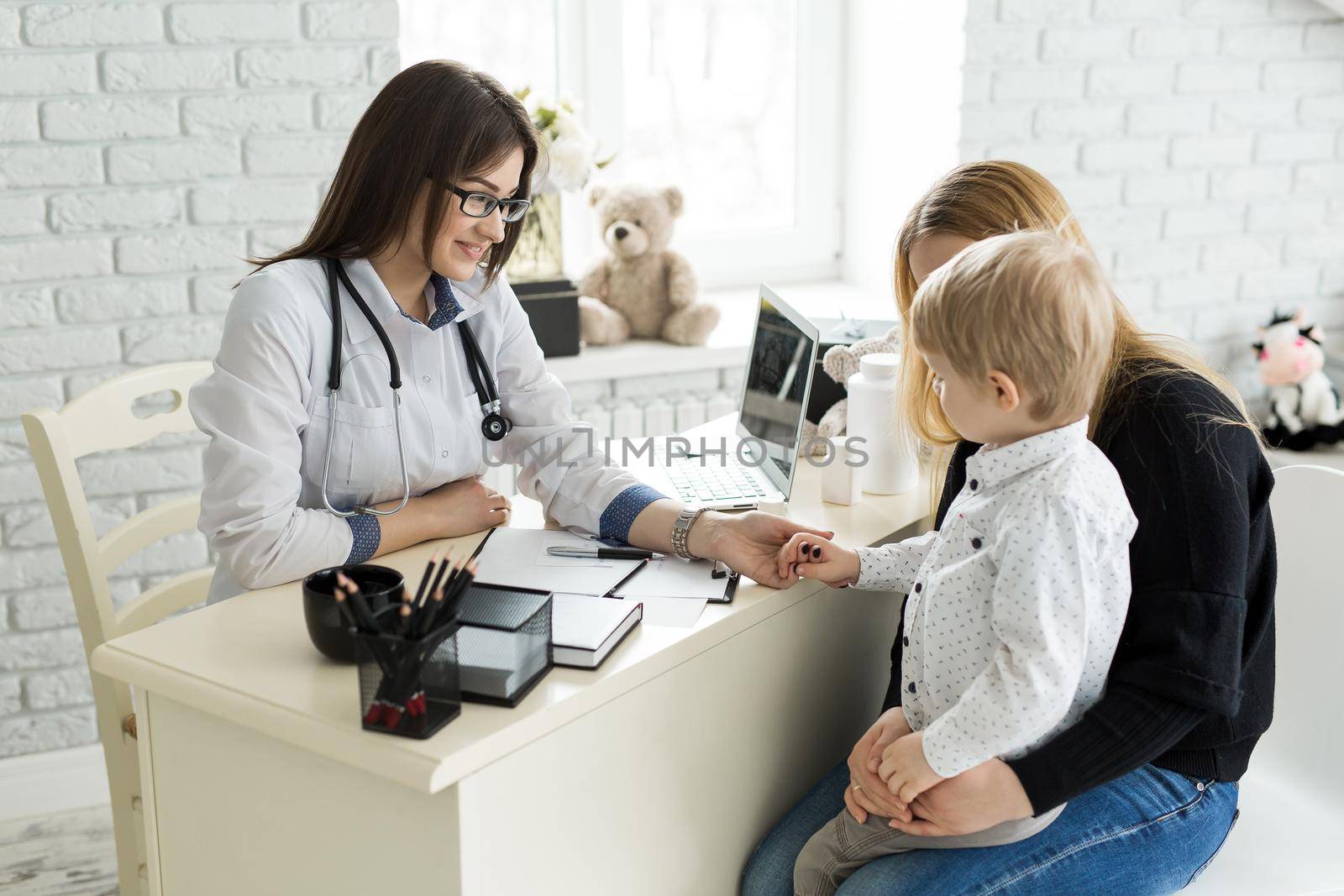 Pediatrician Meeting With Mother And Child In Hospital