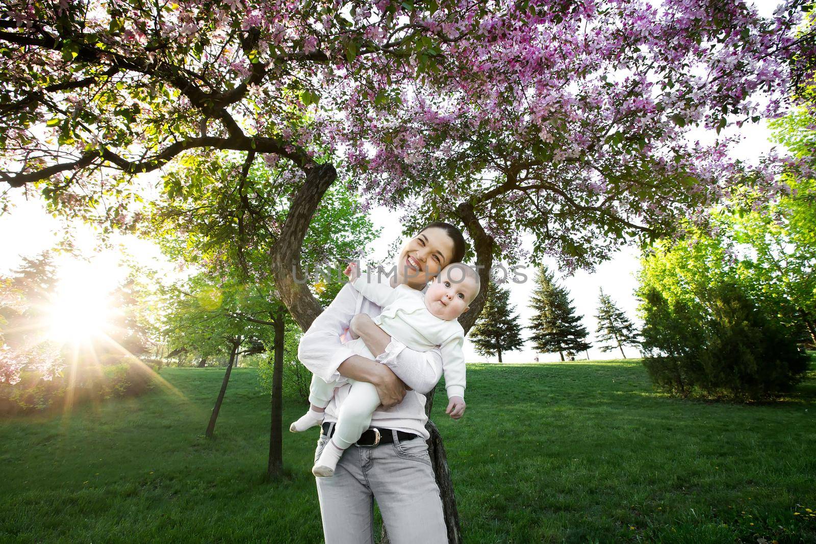 Beautiful Mother And Baby outdoors. Nature. Beauty Mum and her Child playing in Park. by StudioPeace