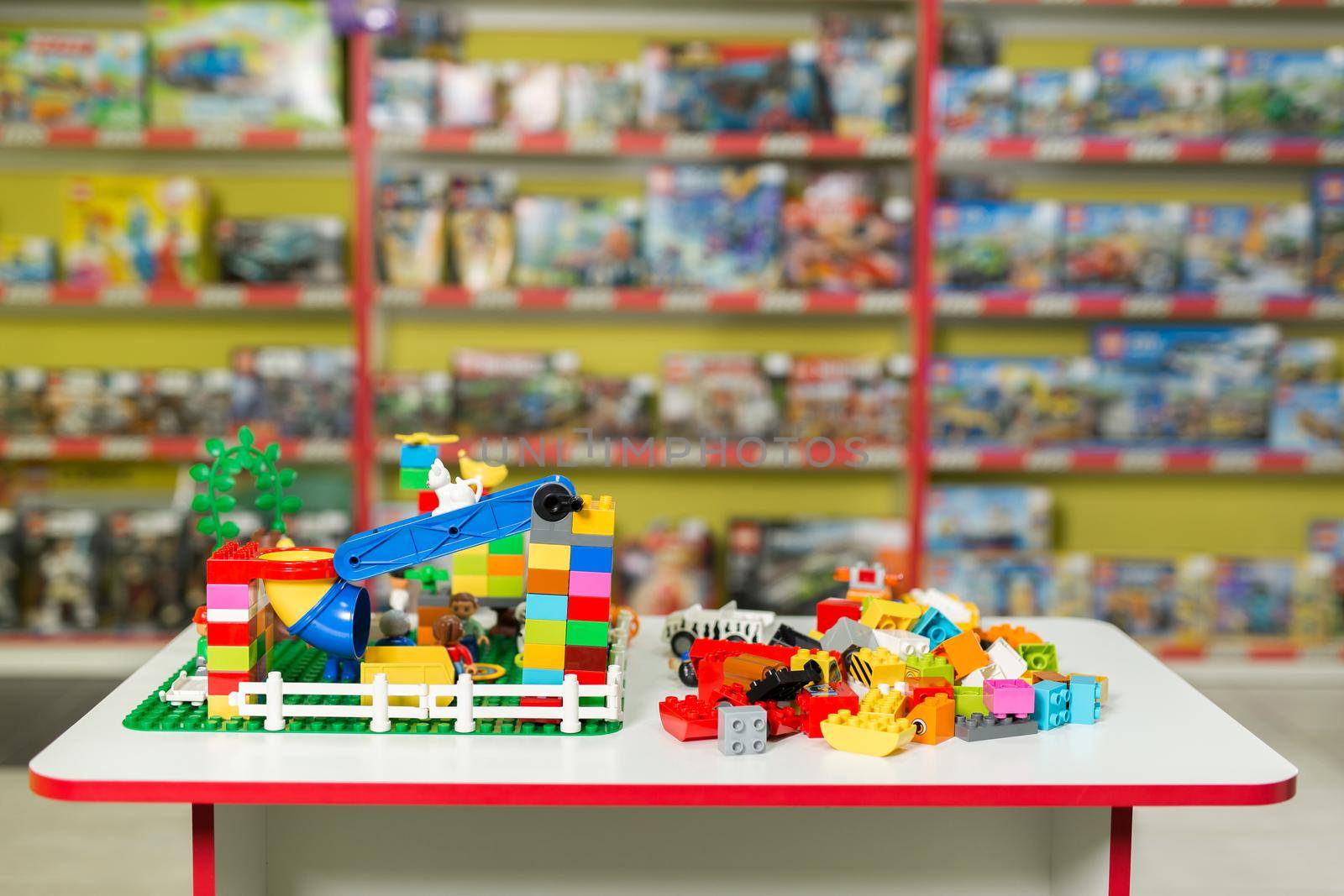 Plastic toy blocks on the white table in the store by StudioPeace