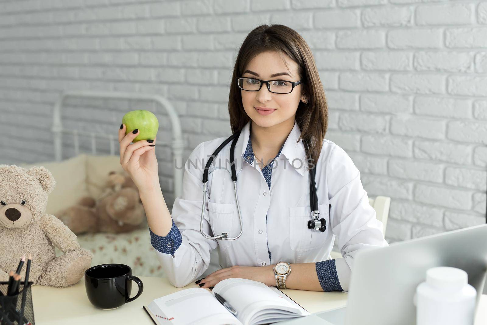 Portert smiling medical doctor woman with apple. by StudioPeace