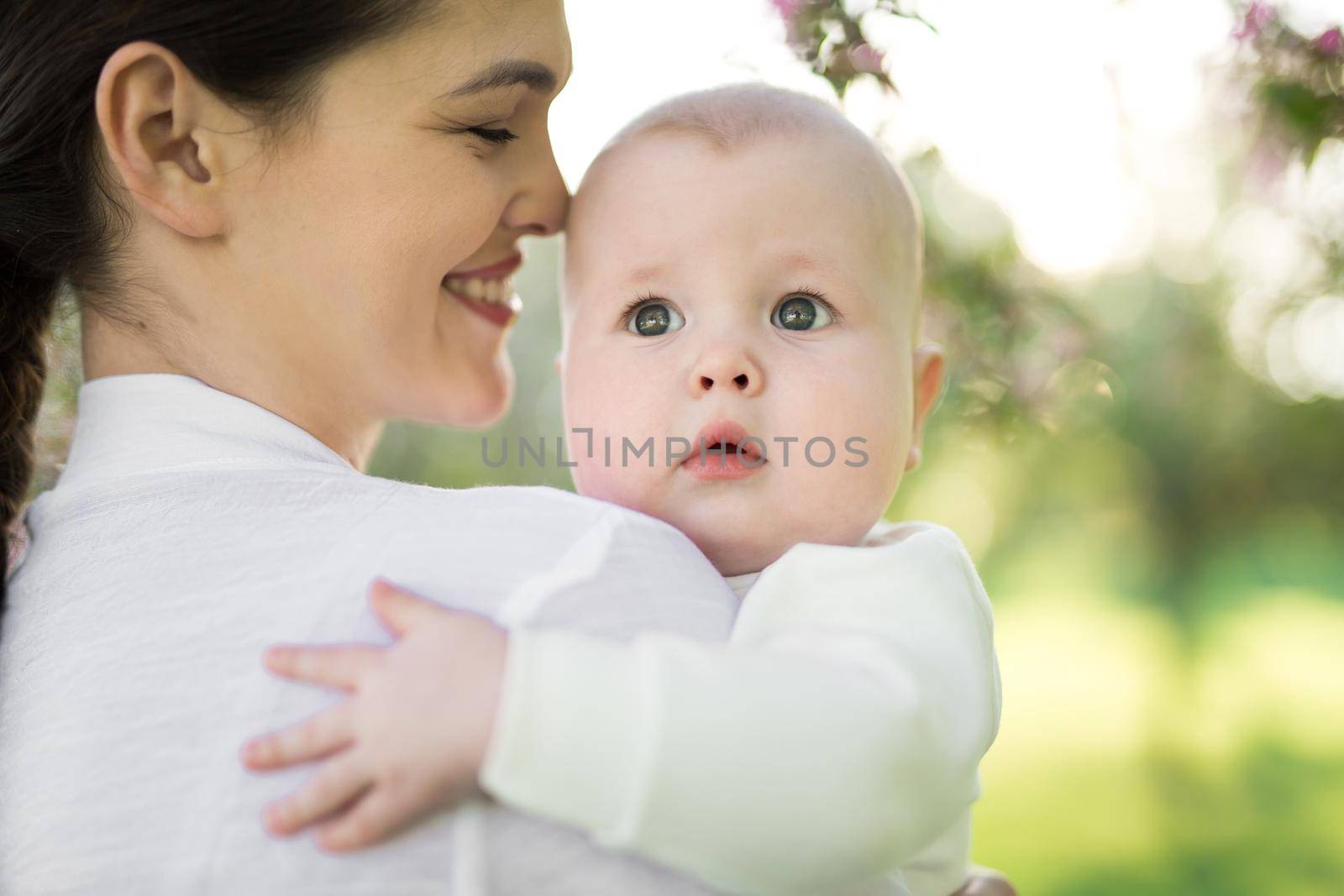 Portrait Beautiful Mother And Baby outdoors. Nature. Beauty Mum and her Child playing in Park