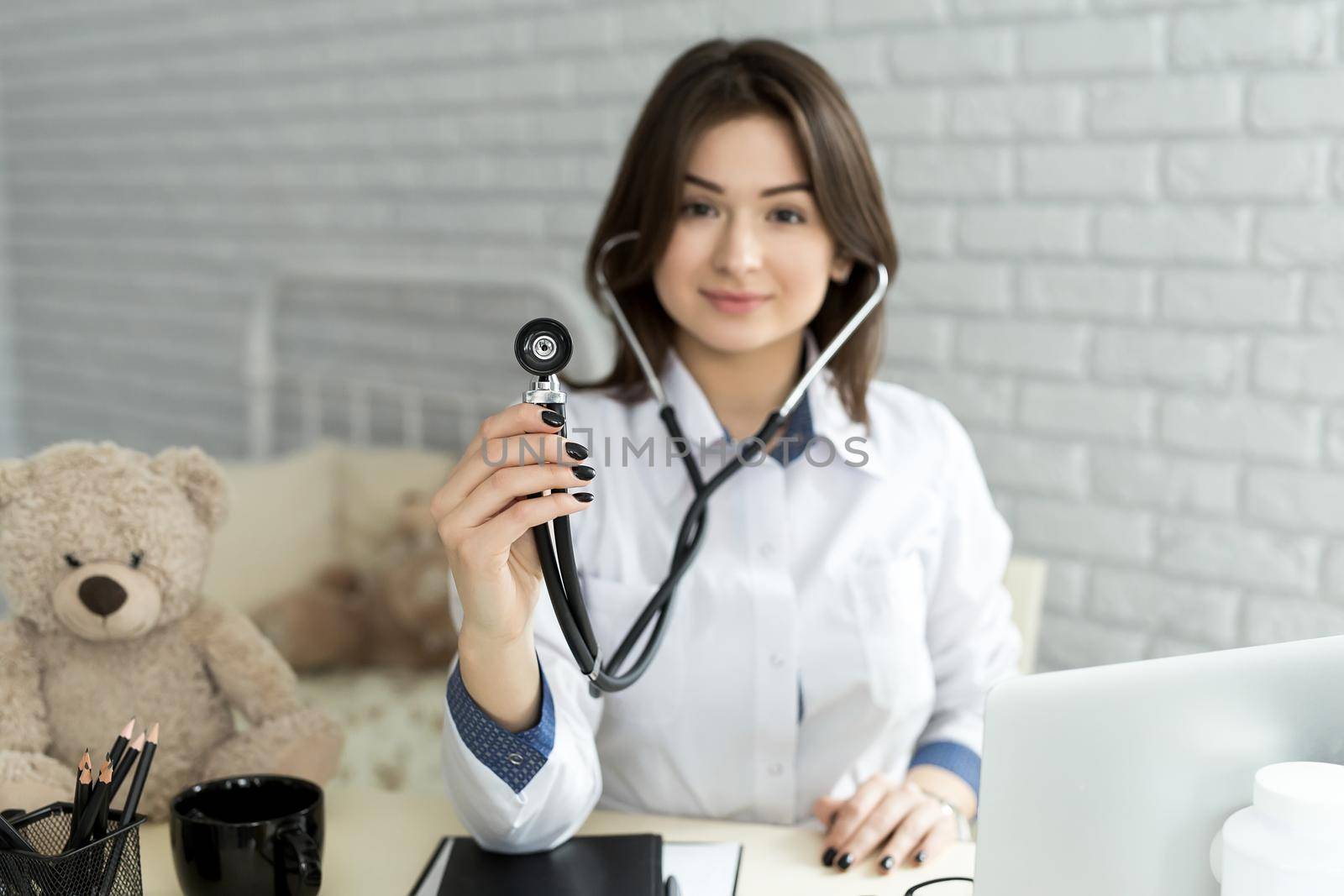 Medical doctor woman holding a stethoscope focus on the stethoscope