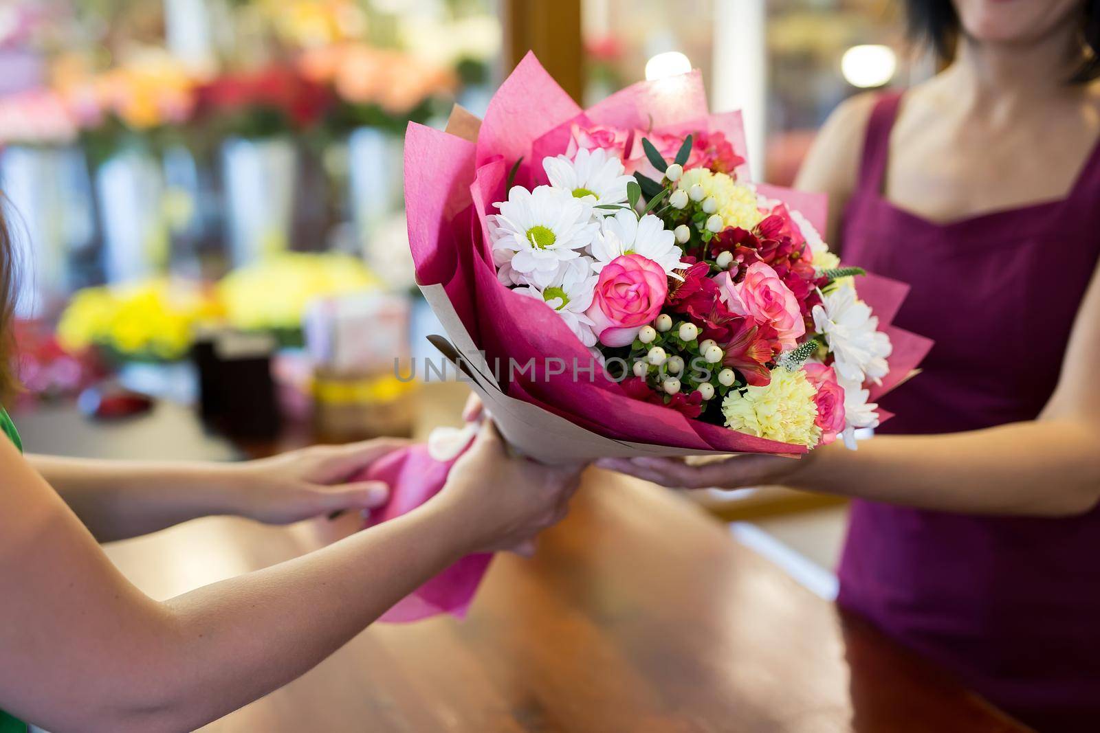 florist will give the client a beautiful flower bouquet. by StudioPeace