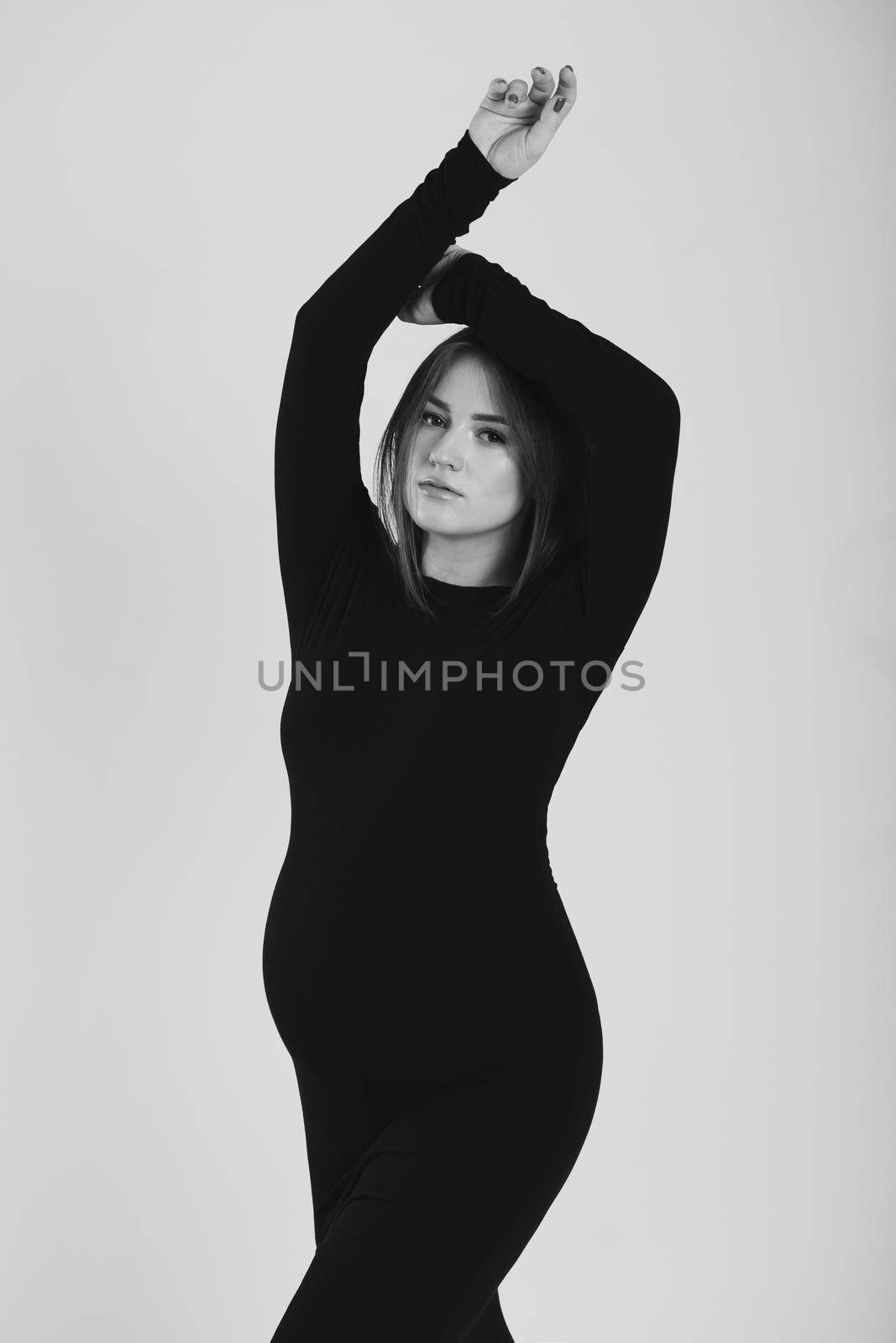 Black and white photo of a pregnant woman on a white background. Silhouette by StudioPeace