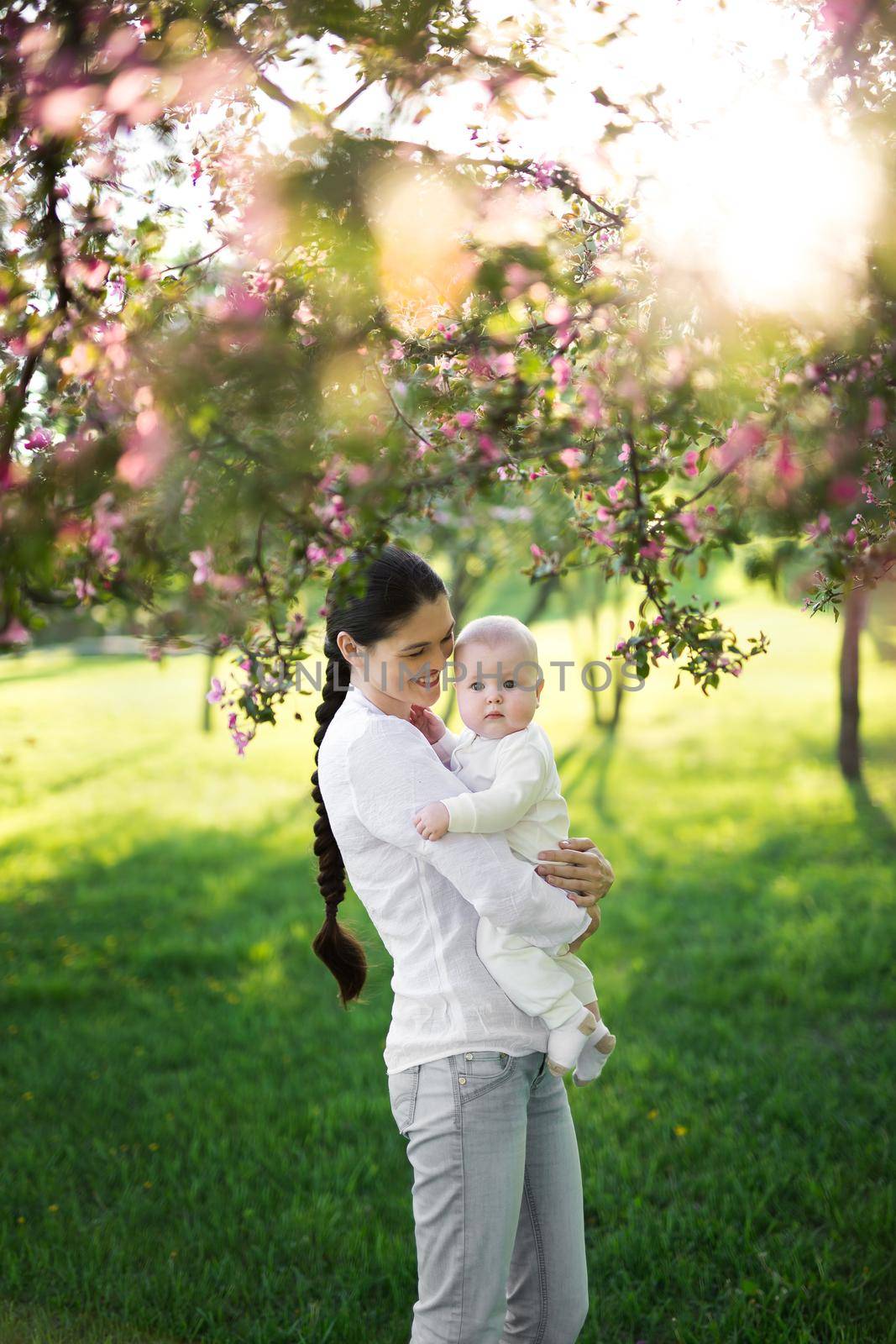 Portrait Beautiful Mother And Baby outdoors. Nature. Beauty Mum and her Child playing in Park