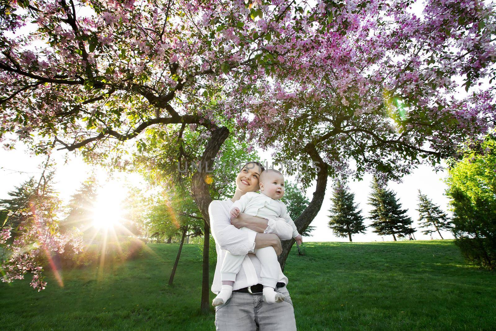 Beautiful Mother And Baby outdoors. Nature. Beauty Mum and her Child playing in Park