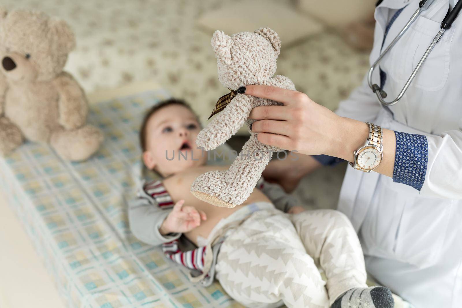 Doctor examining a baby in a hospital. by StudioPeace