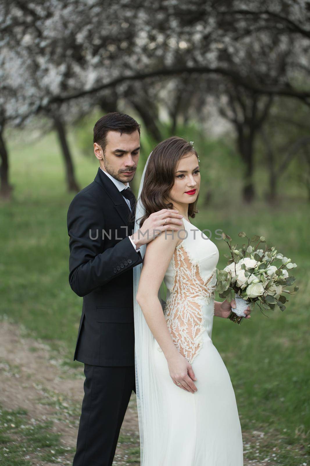 Bride and groom in the green forest