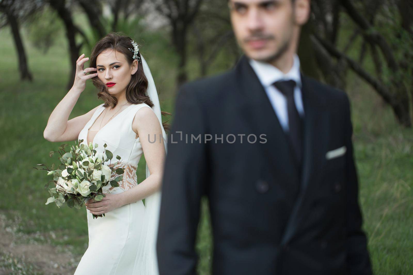 Bride and groom in the green forest