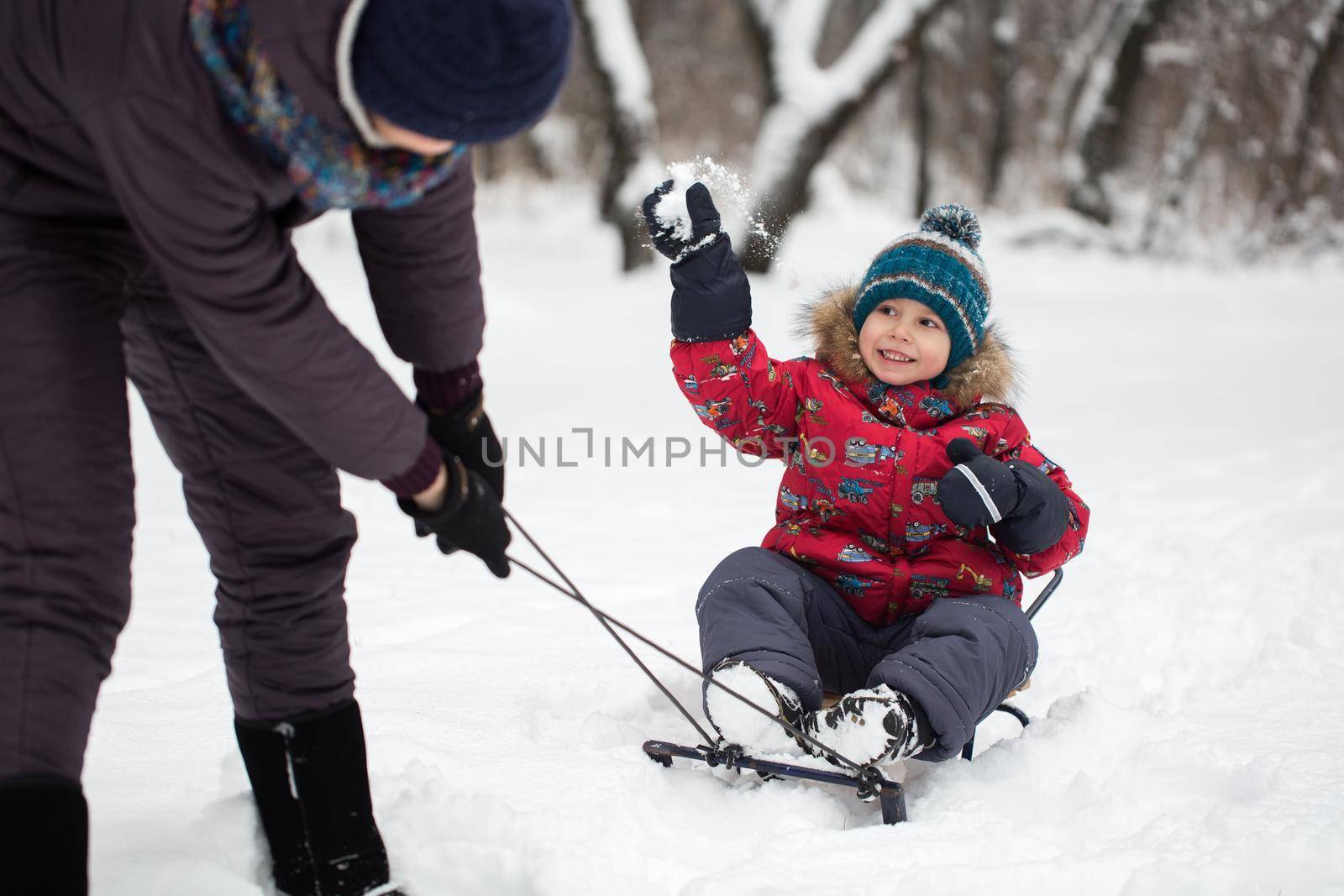 Happy mother and baby in winter park