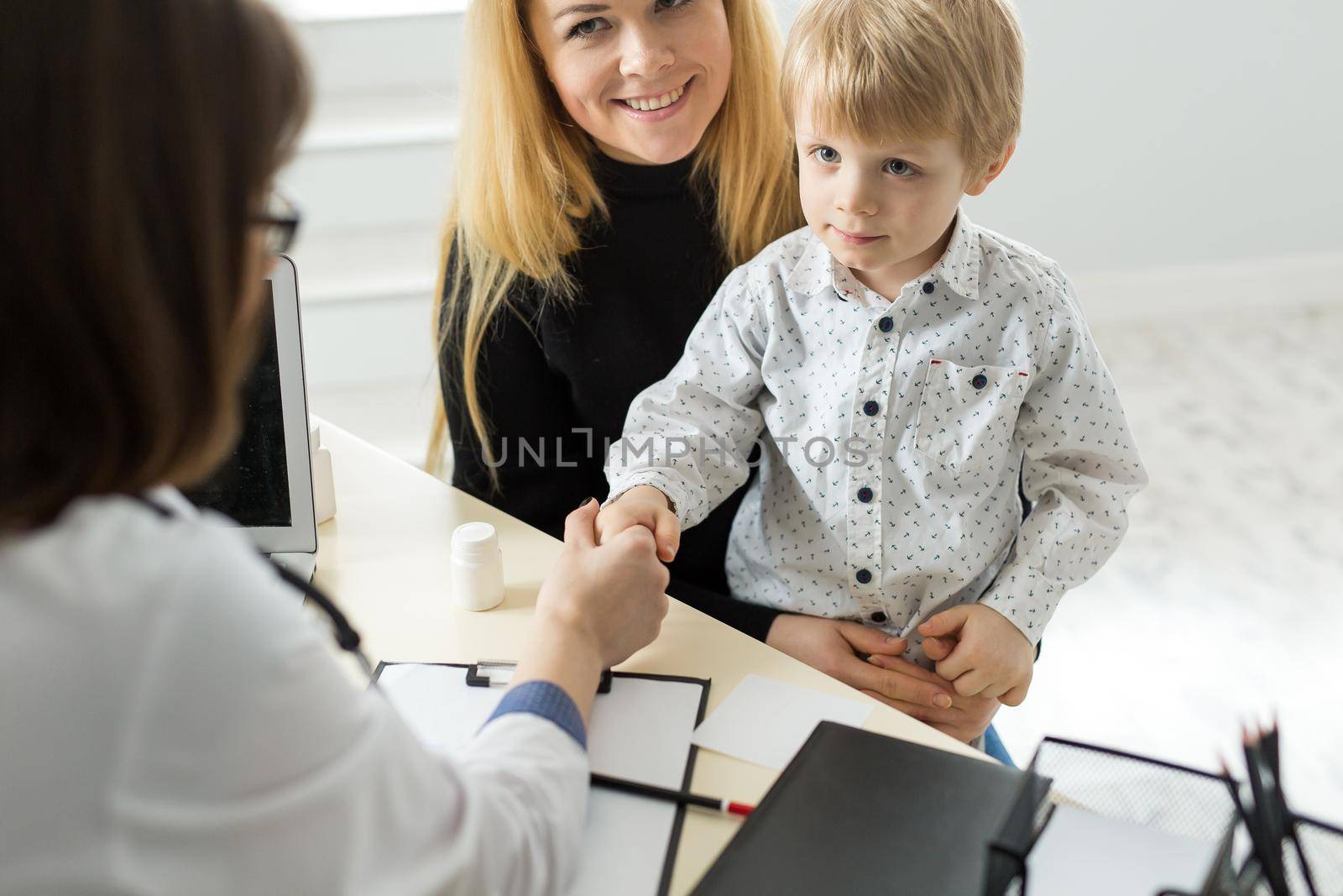 Pediatrician Meeting With Mother And Child In Hospital