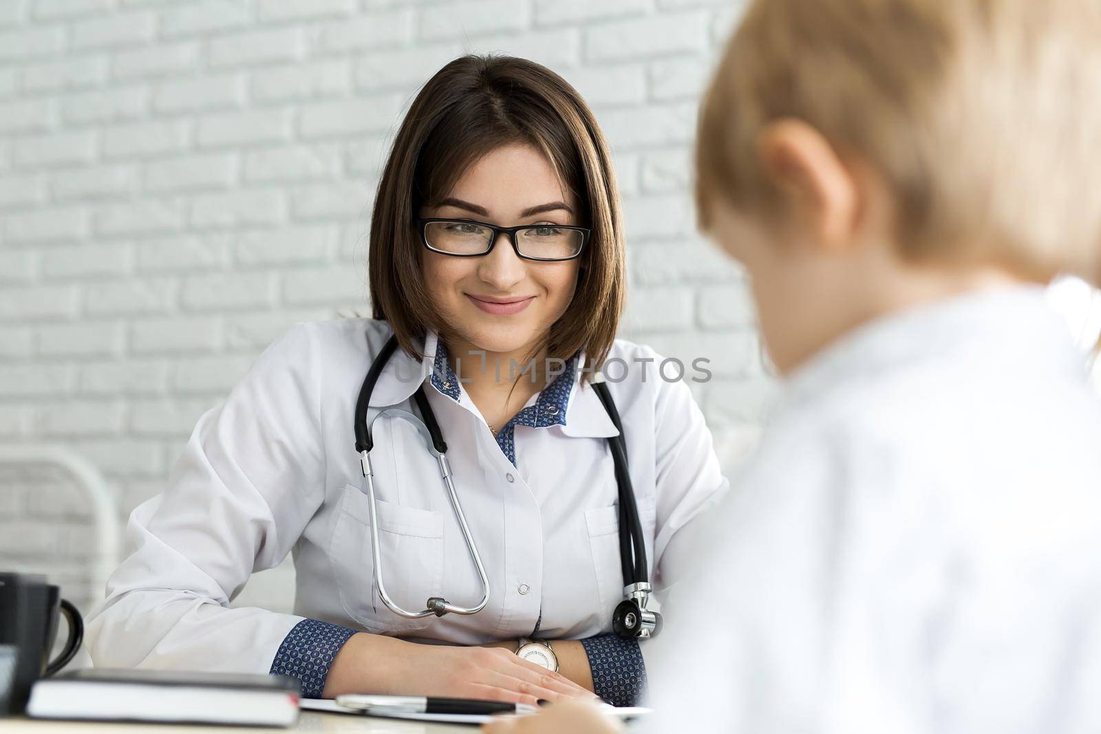 Pediatrician Meeting With Mother And Child In Hospital