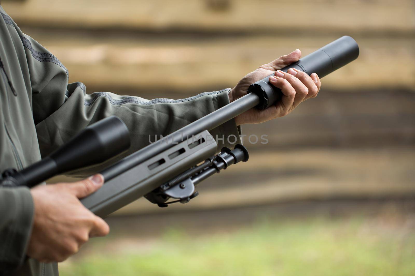 Military holds a pistol with a silencer by StudioPeace