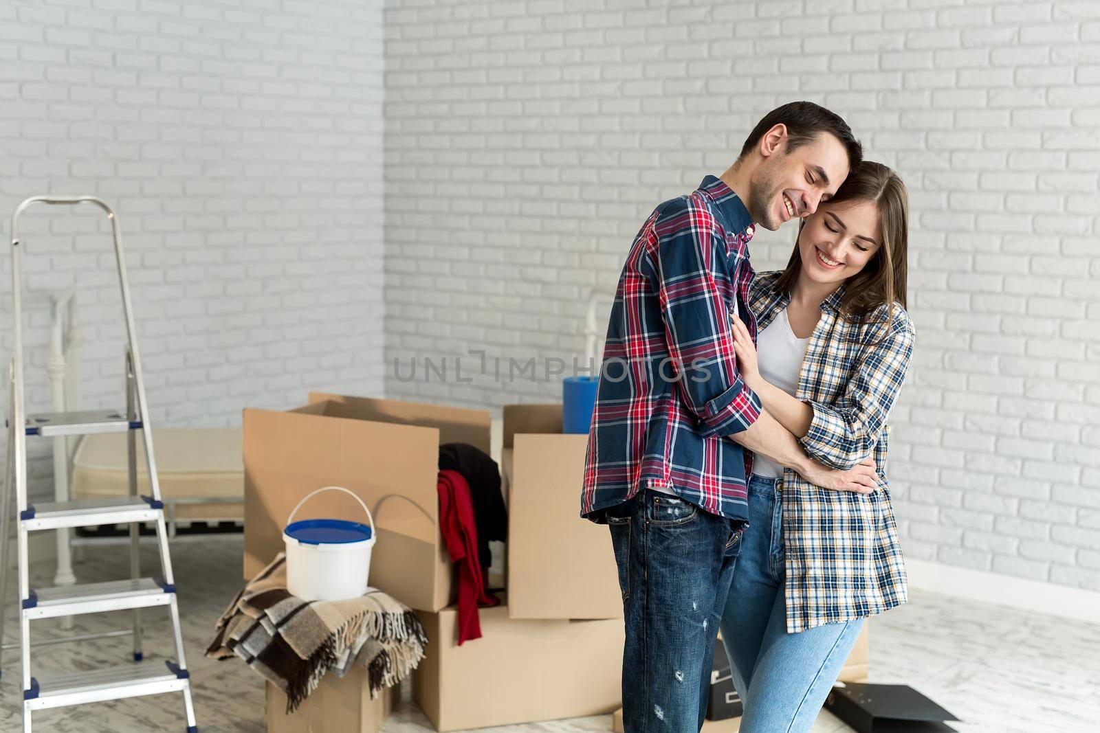 Happy young couple moving together in new apartment. by StudioPeace
