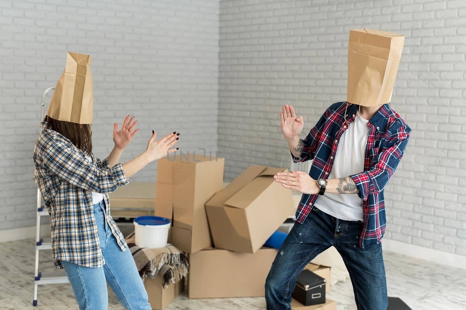 Couple With Cardboard Boxes On Their Heads. by StudioPeace