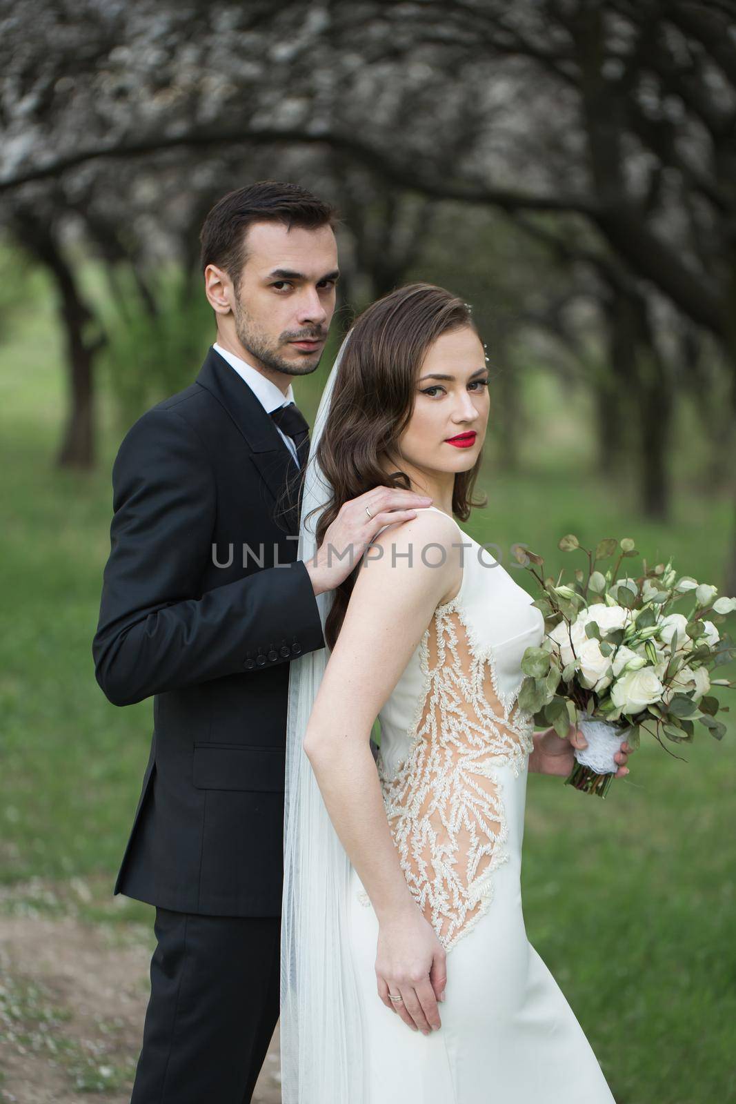 Bride and groom in the green forest. by StudioPeace