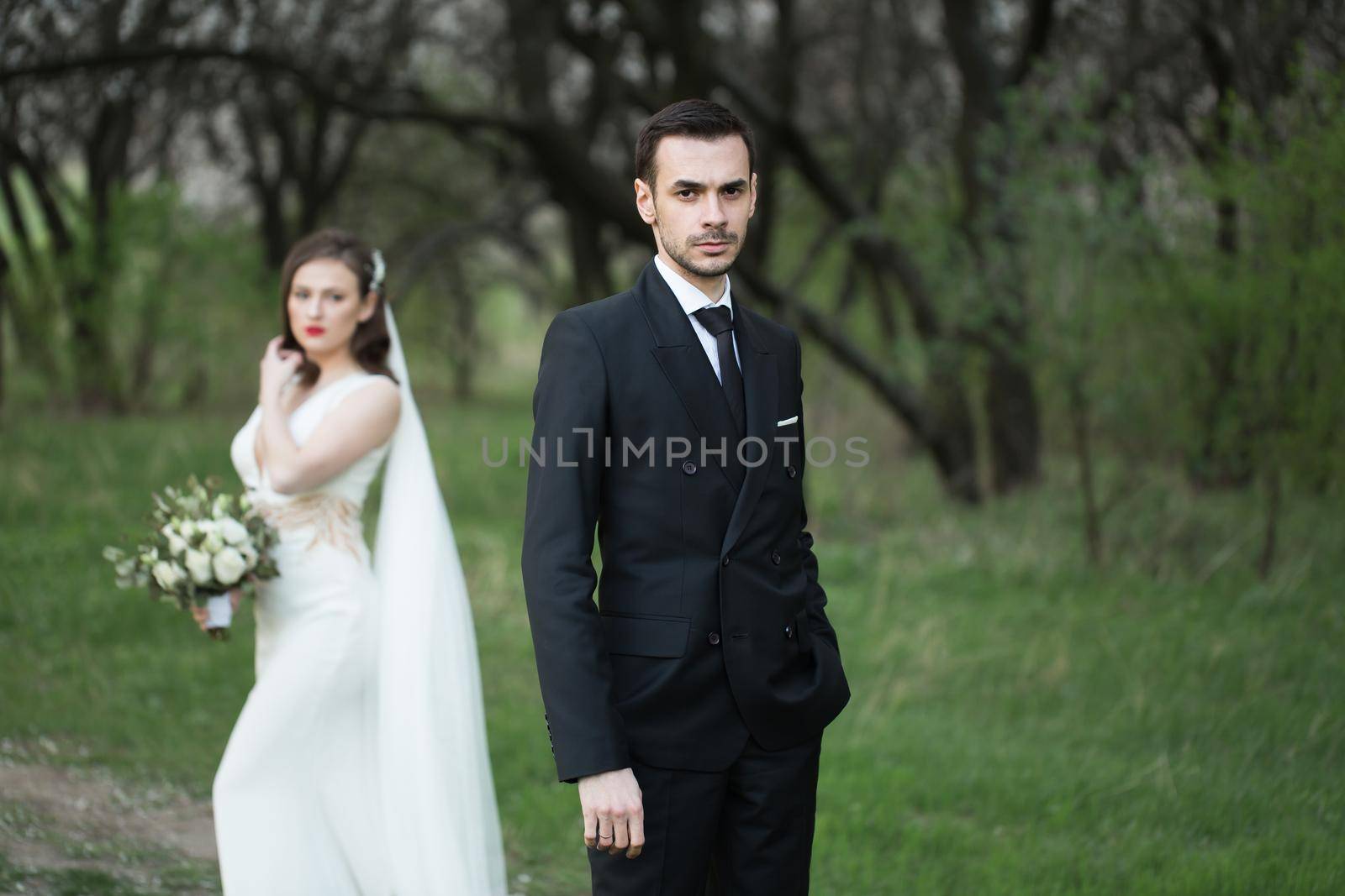 Bride and groom in the green forest. by StudioPeace