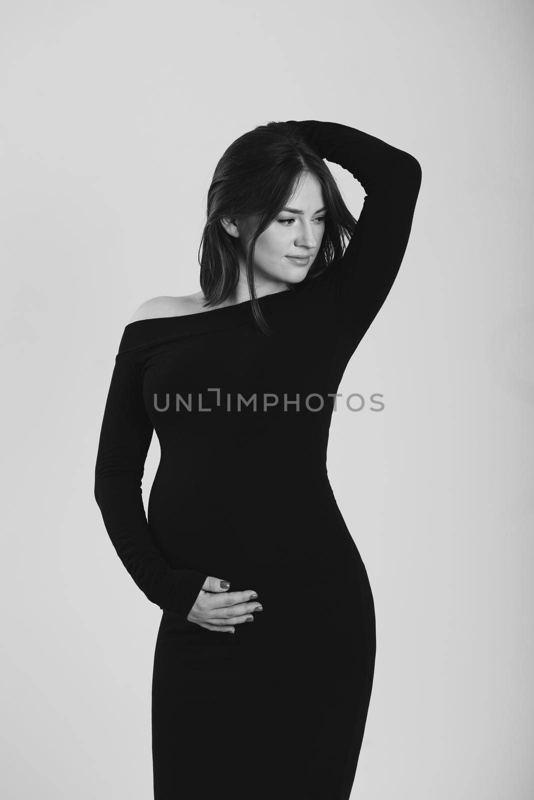 Black and white photo of a pregnant woman on a white background. Silhouette by StudioPeace