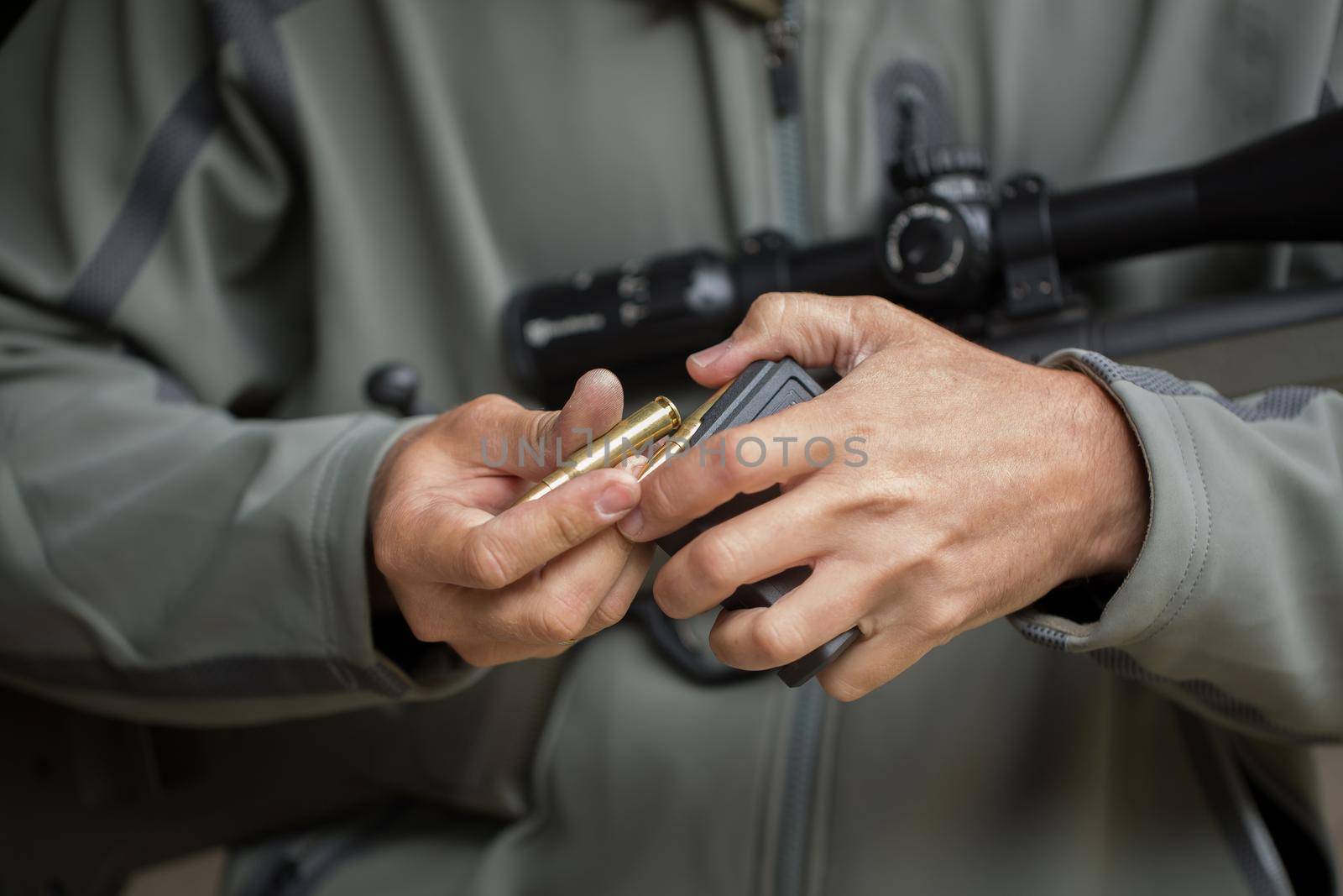 Loading ammunition into a clip. Reloading weapons. by StudioPeace