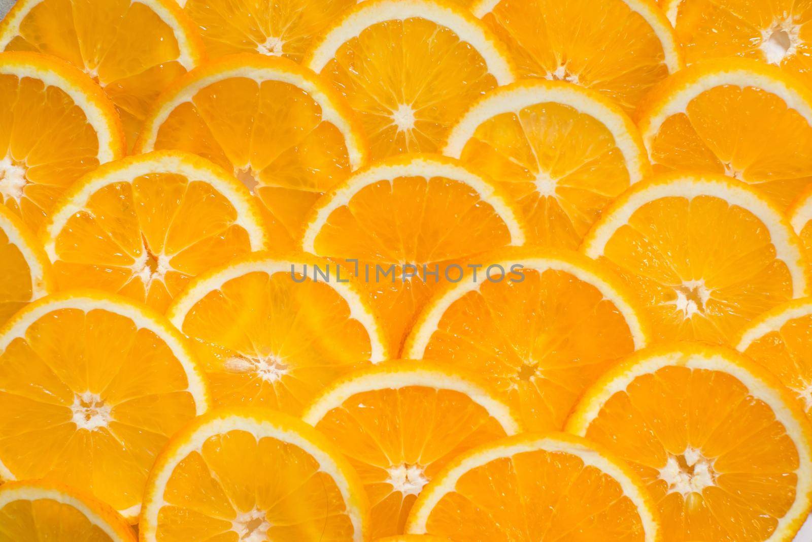 Bright orange background from slices of juicy Orange. Healthy food, background by StudioPeace