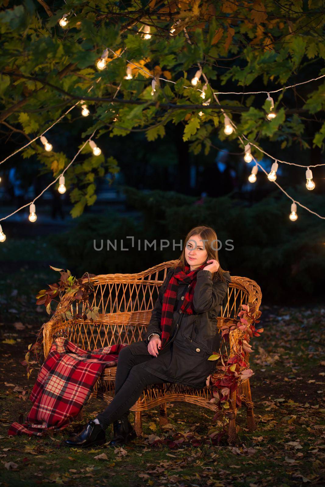 Beautiful girl sitting on a bench in autumn Park. by StudioPeace