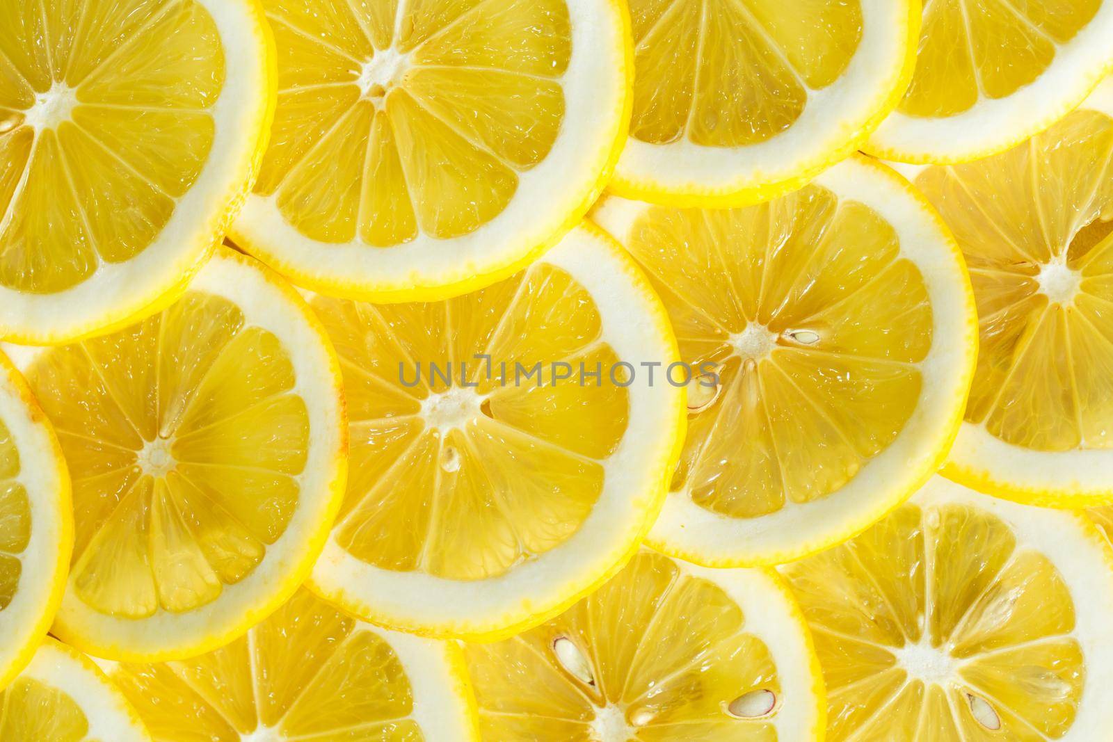 A slices of fresh yellow lemon texture background pattern. by StudioPeace