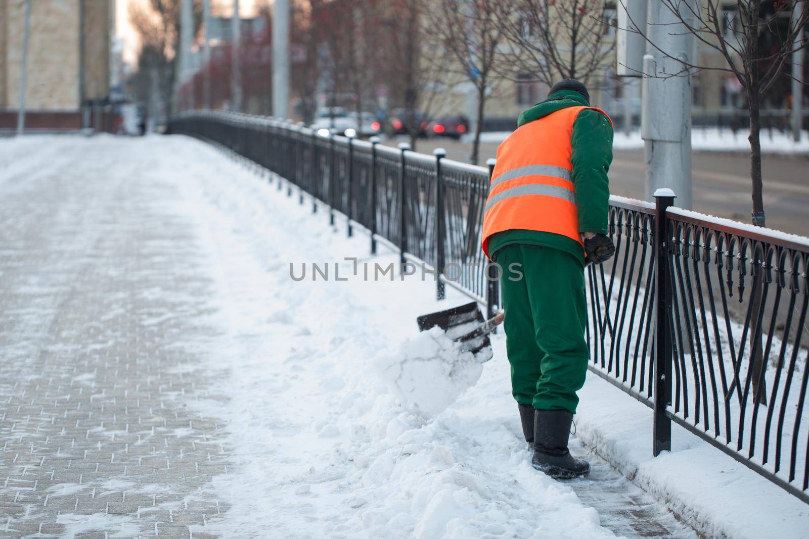 Workers sweep snow from road in winter, Cleaning road from snow storm by StudioPeace