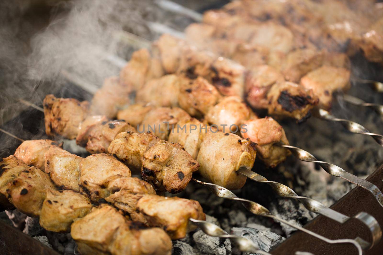 Marinated shashlik preparing on a barbecue grill over charcoal. Shashlik or Shish kebab popular in Eastern Europe. Shashlyk skewered meat was originally made of lamb. Roast Beef Kebabs On BBQ Grill. by StudioPeace