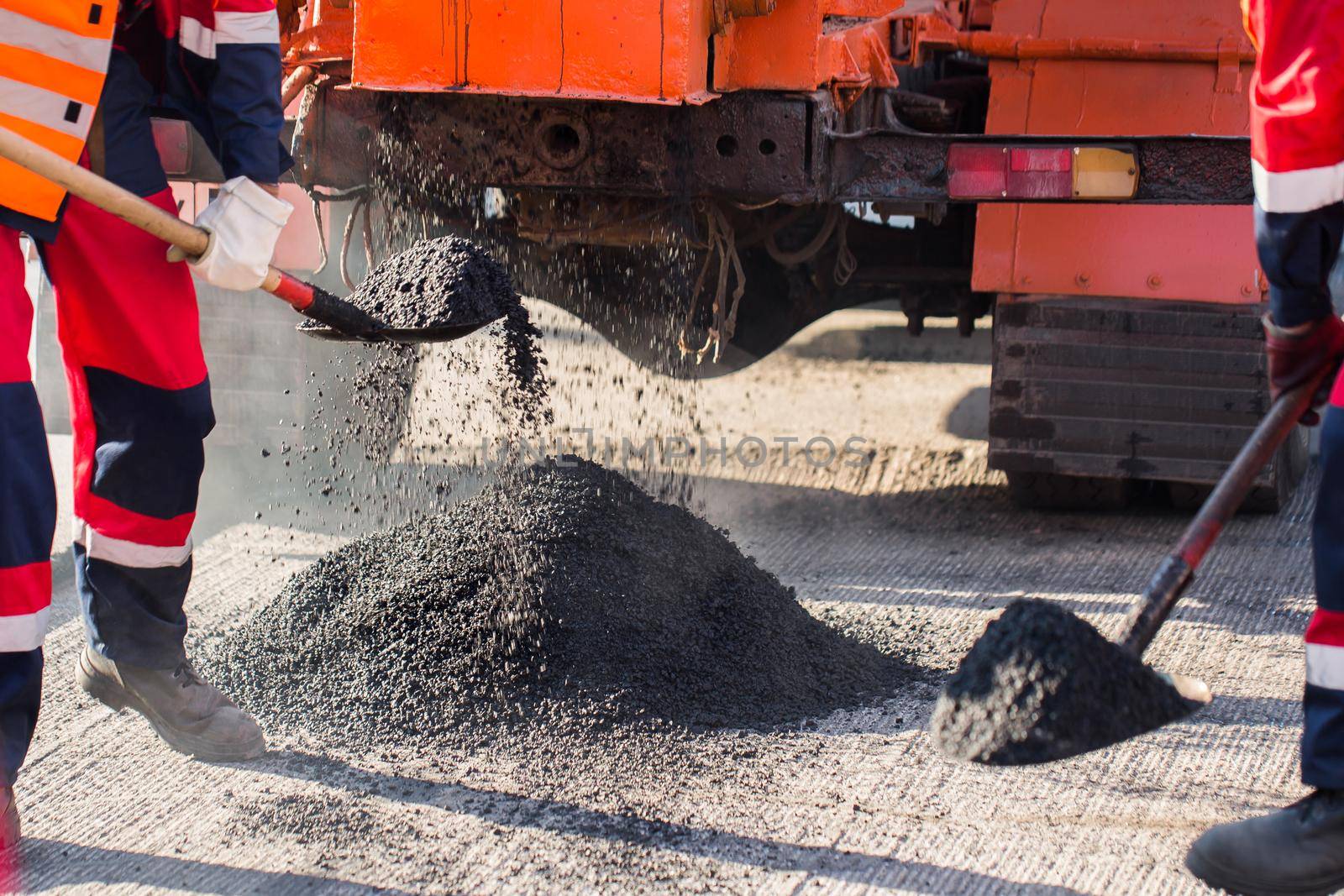 Repair of roads, highways and sidewalks. Patching. Working with a shovel falls asleep in the pit