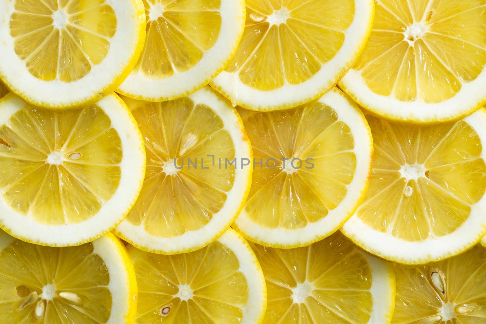 A slices of fresh yellow lemon texture background pattern. by StudioPeace