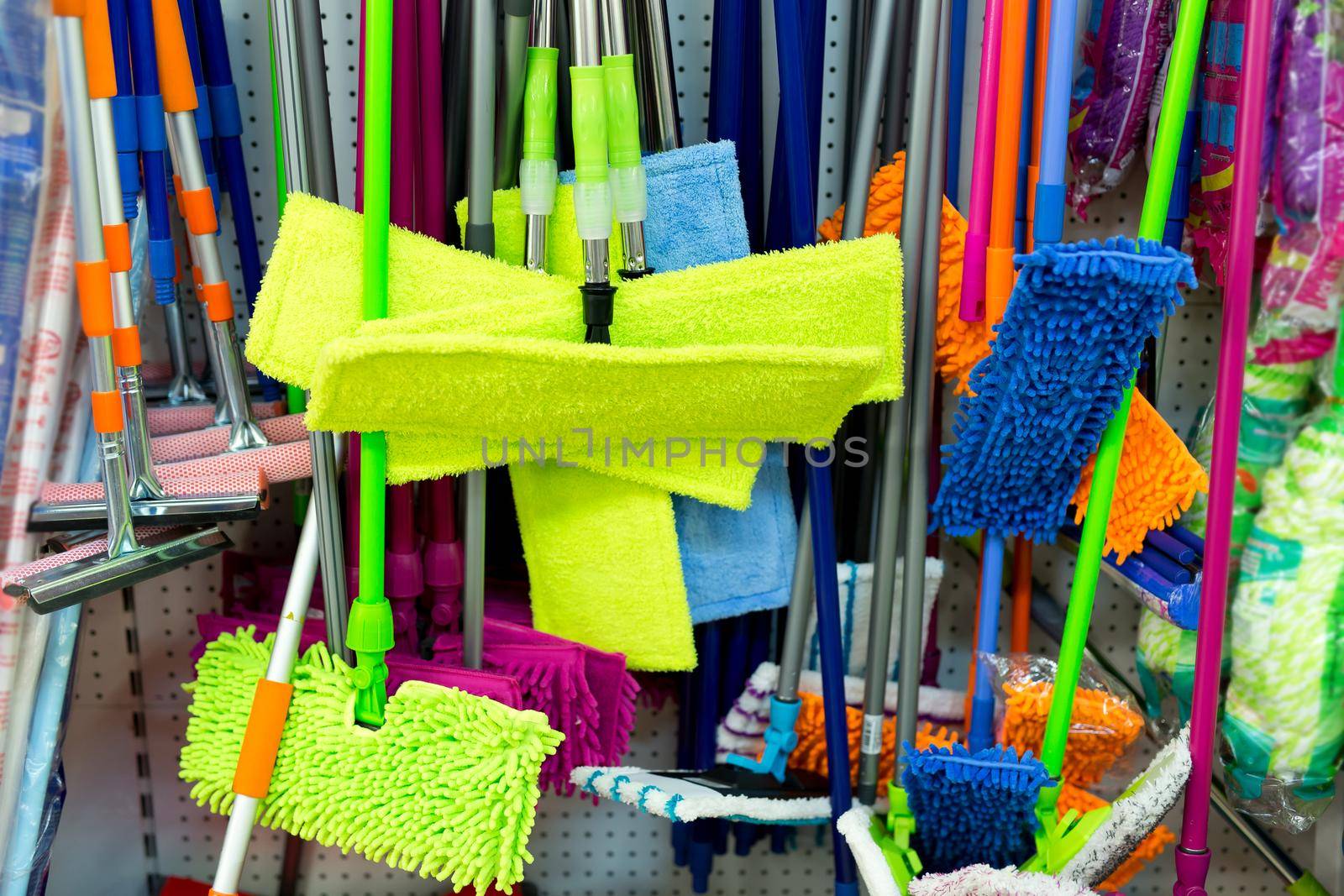 Lots of sponges, rags and mops on shelves in the supermarket