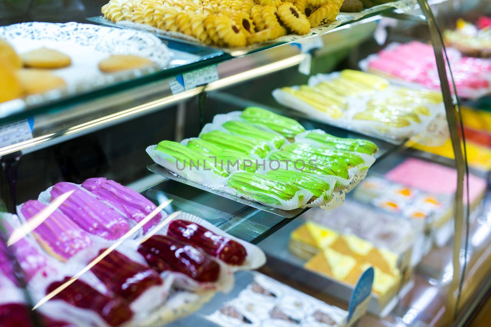 Pastry shop with variety of donuts, muffins, creme brulee, cakes in the supermarket