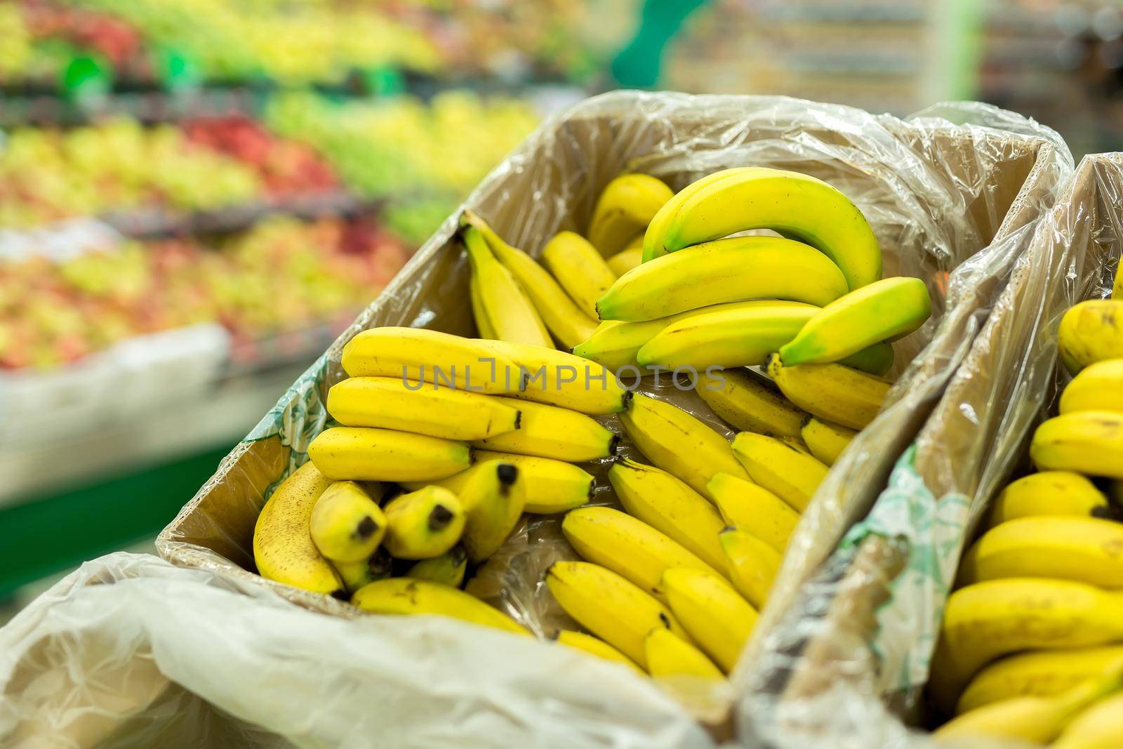 Bananas in the boxes in the supermarket. by StudioPeace