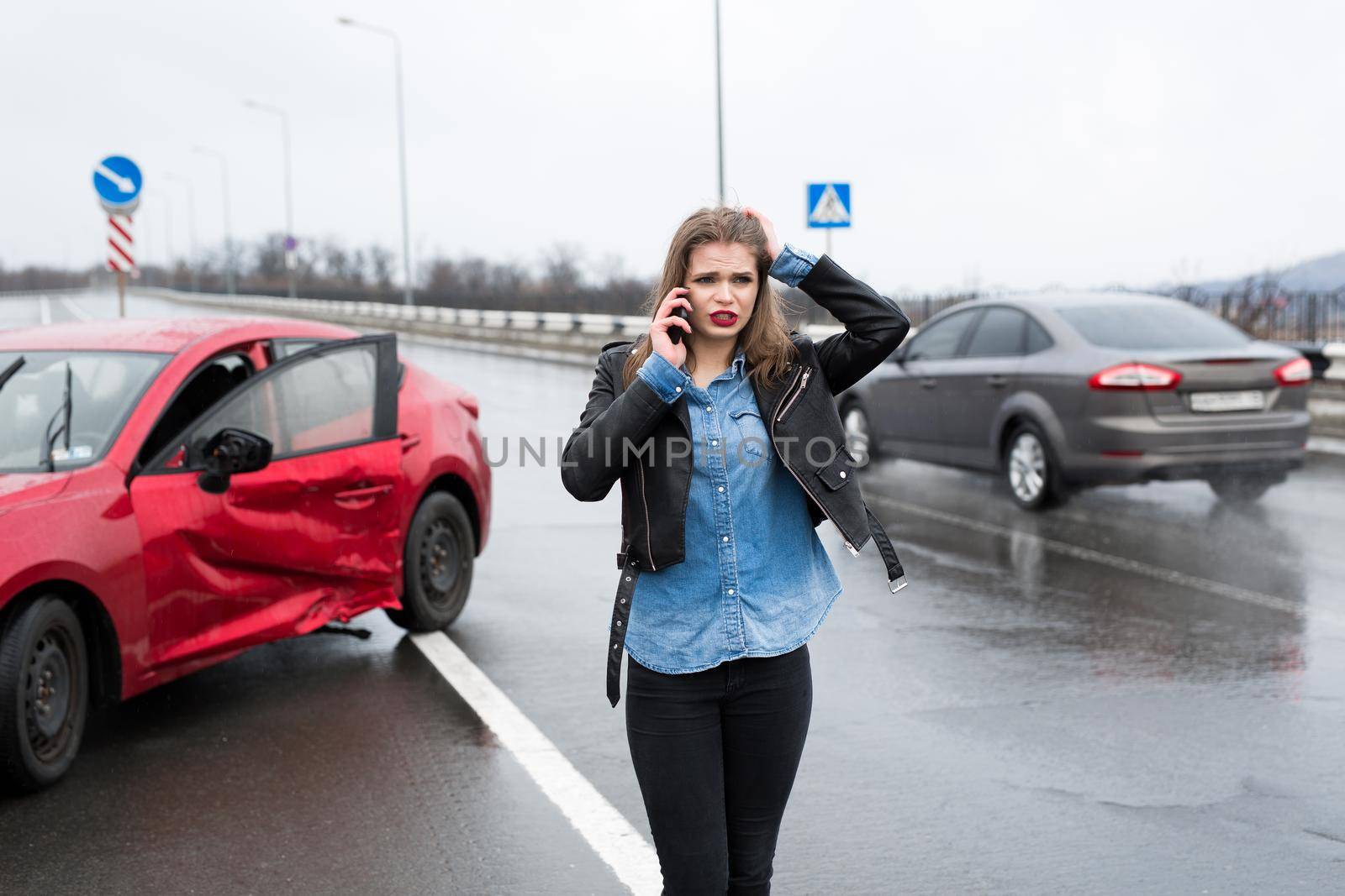 Woman calls to a service standing by a red car. by StudioPeace