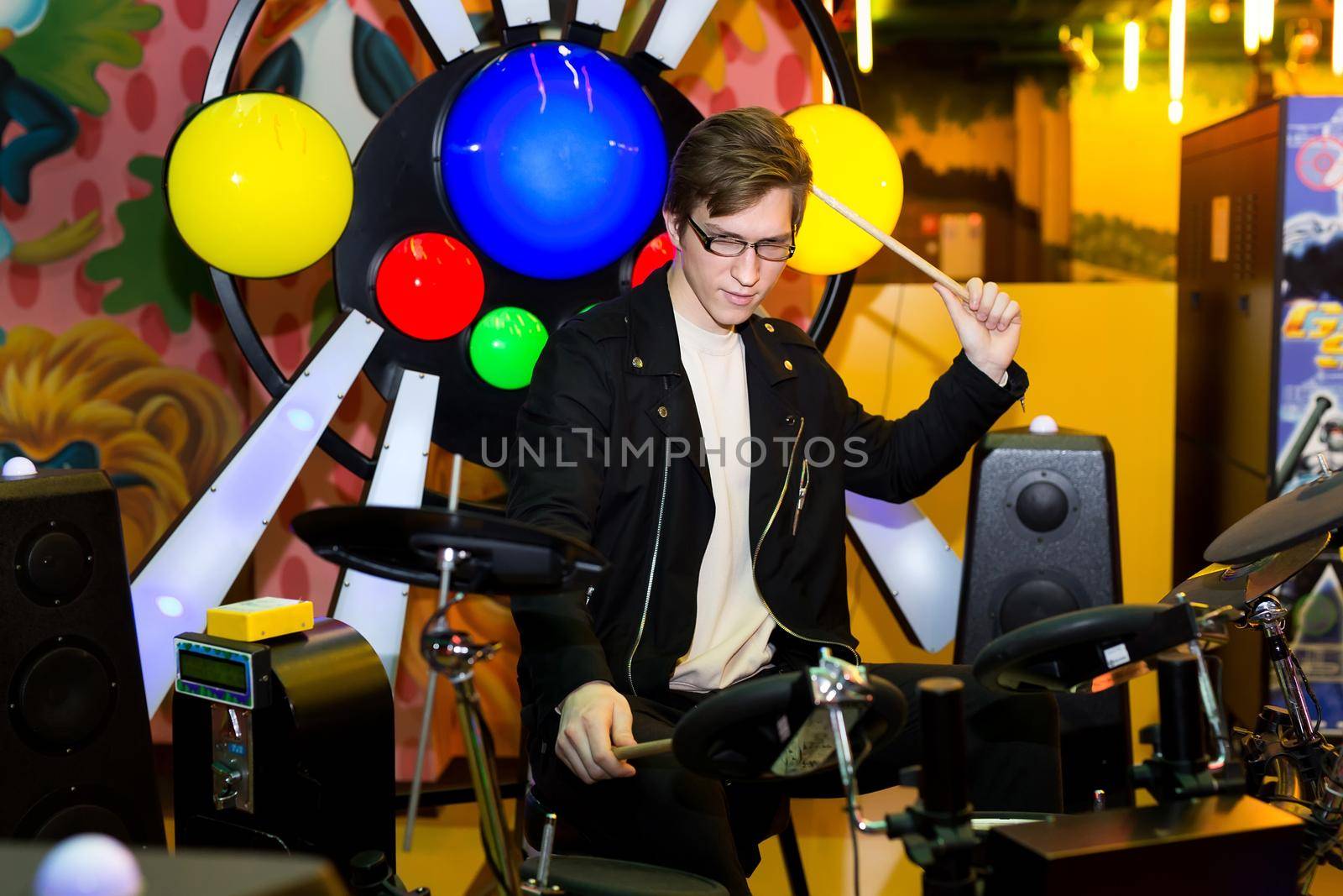 Young man playing on the electronic drums