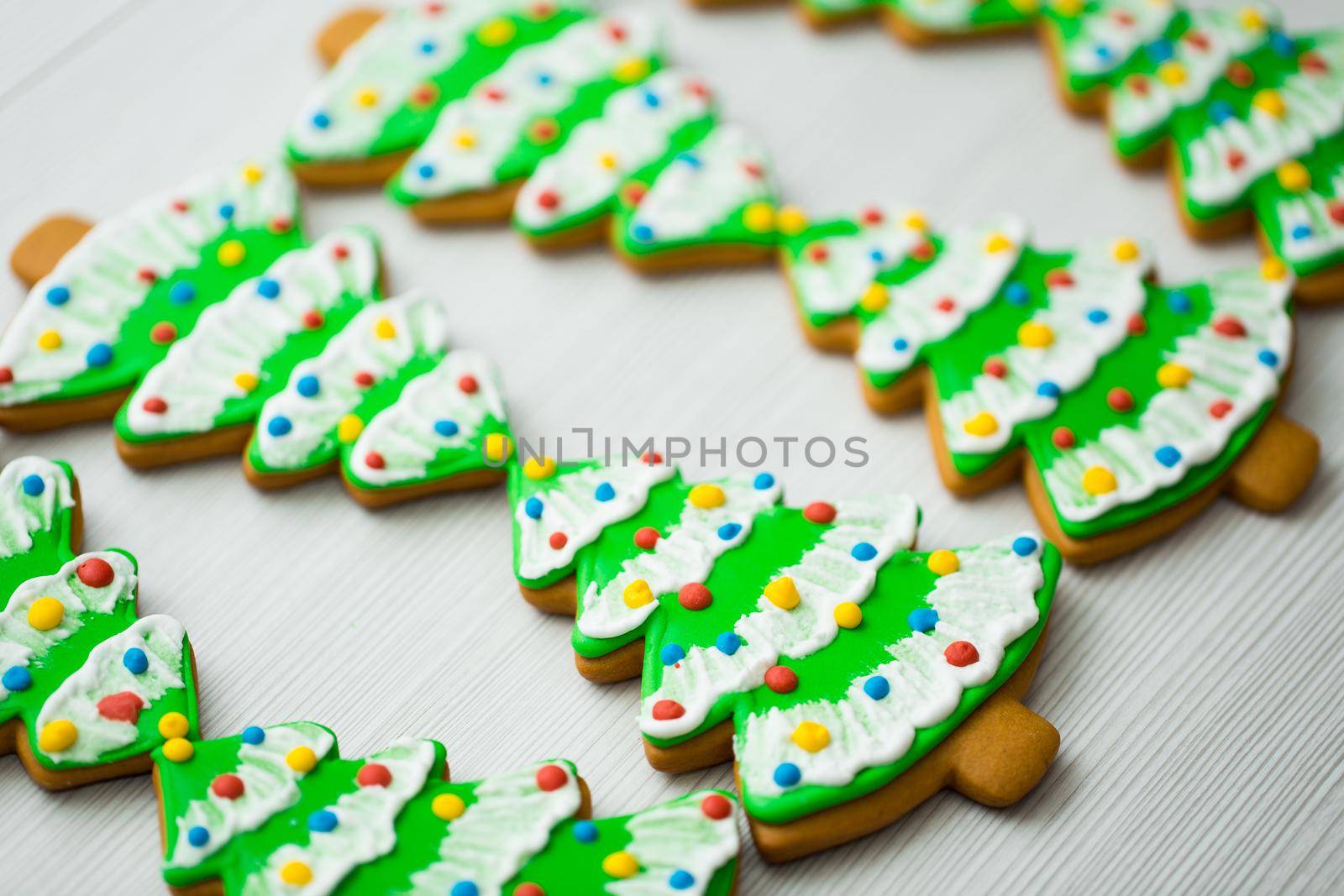 Gingerbread in the shape of a Christmas tree on a white background.