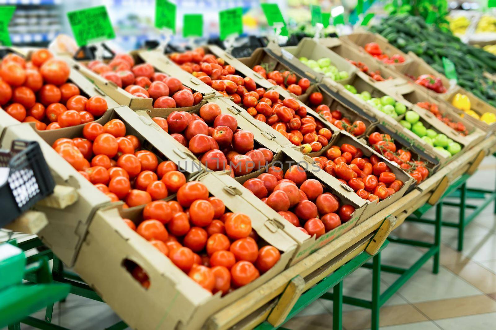 Fresh red tomatoes in boxes in the supermarket