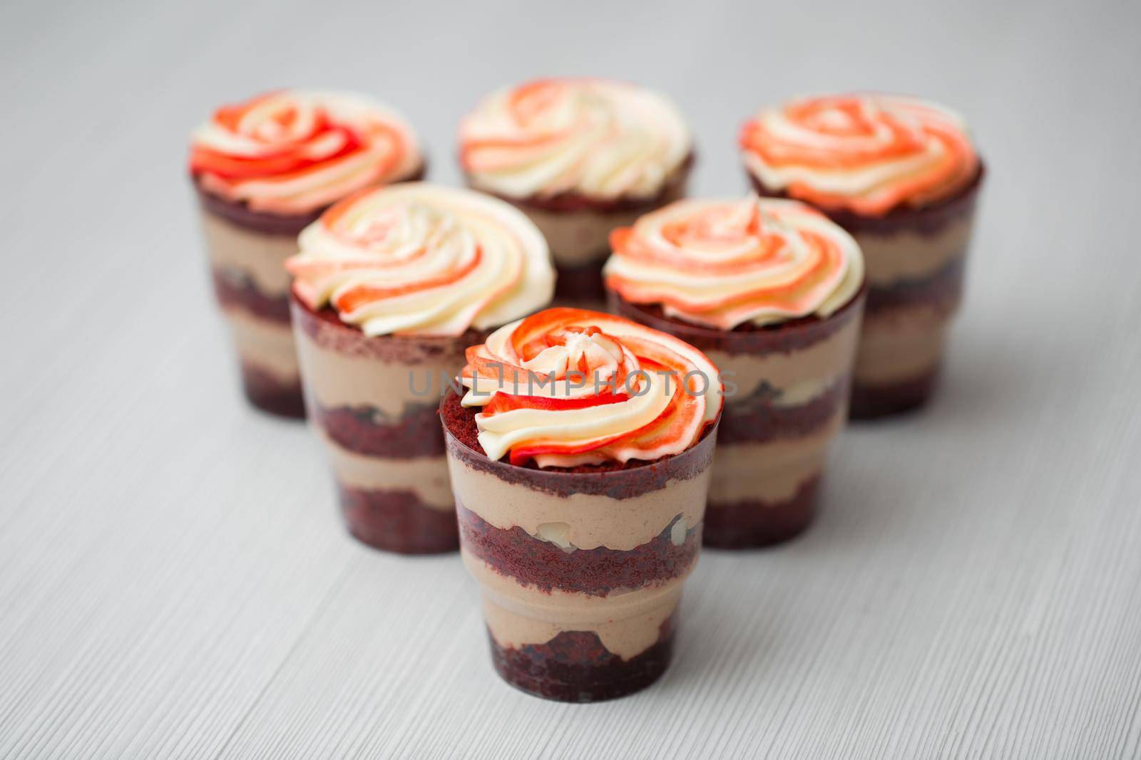 Chocolate and mousse trifle dessert in plastic cups.