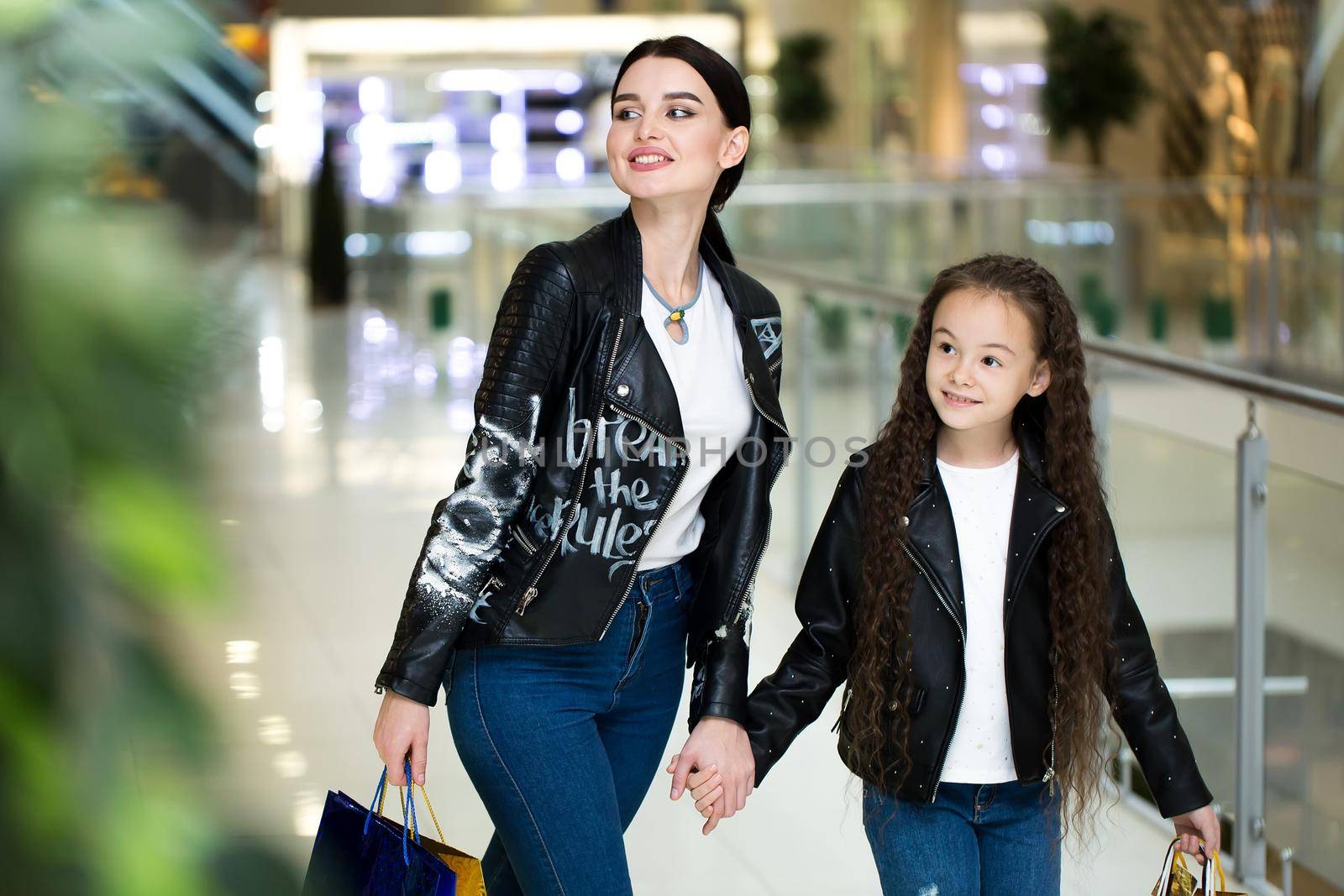 sale, consumerism and people concept - happy mother and child with shopping bags