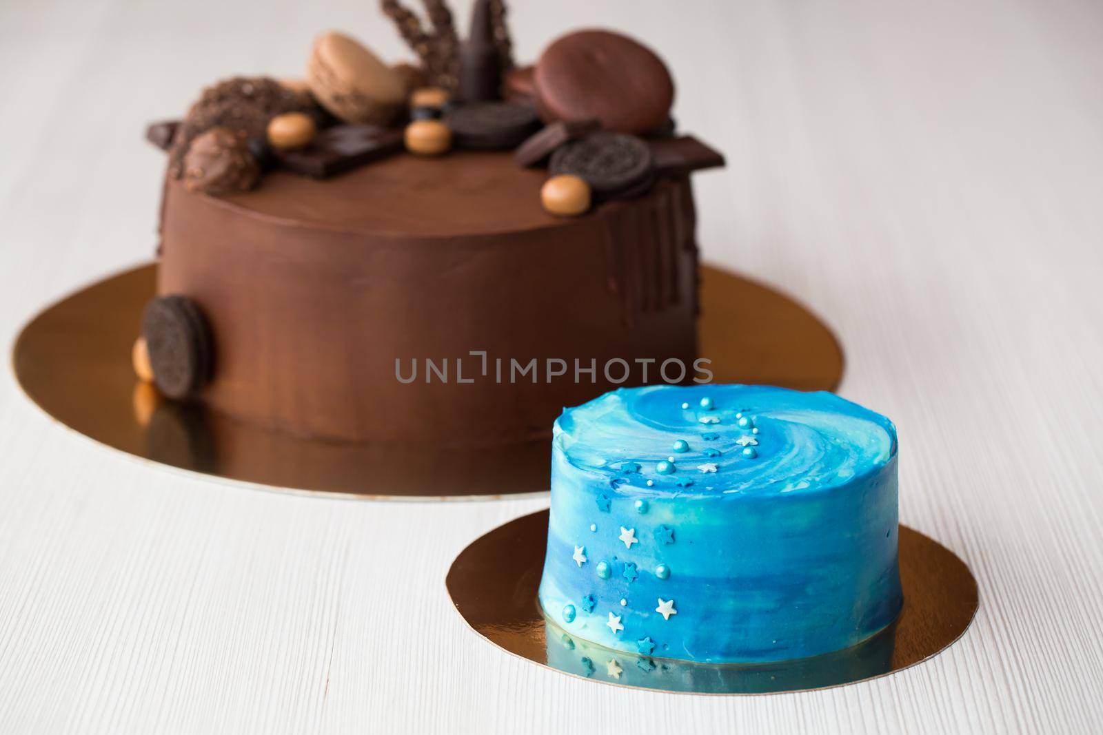 Space cake blue on the background of a large chocolate cake